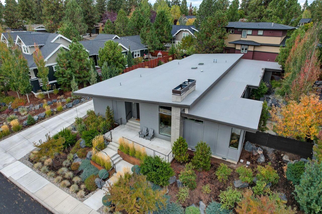 This stunning single-level custom home in Bend's highly sought-after Northwest Crossing offers luxury and privacy in a prime location. Sitting on a premium lot overlooking lush green space, this home boasts an open floor plan with large windows that invite natural light while maintaining your privacy. The chef's kitchen features a 6'x6' island, custom cabinetry, and JennAir appliances. Gorgeous wide-plank French white oak floors flow throughout, complementing the vaulted ceilings that add to the walk-in closet. Enjoy outdoor living with a covered patio, fire pit, and a bonus enclosed patio with turf for your pet. The 3-car garage offers plenty of space, with easy no-step access into the home. Just minutes from shopping, dining, and outdoor recreation. This home has it all!
