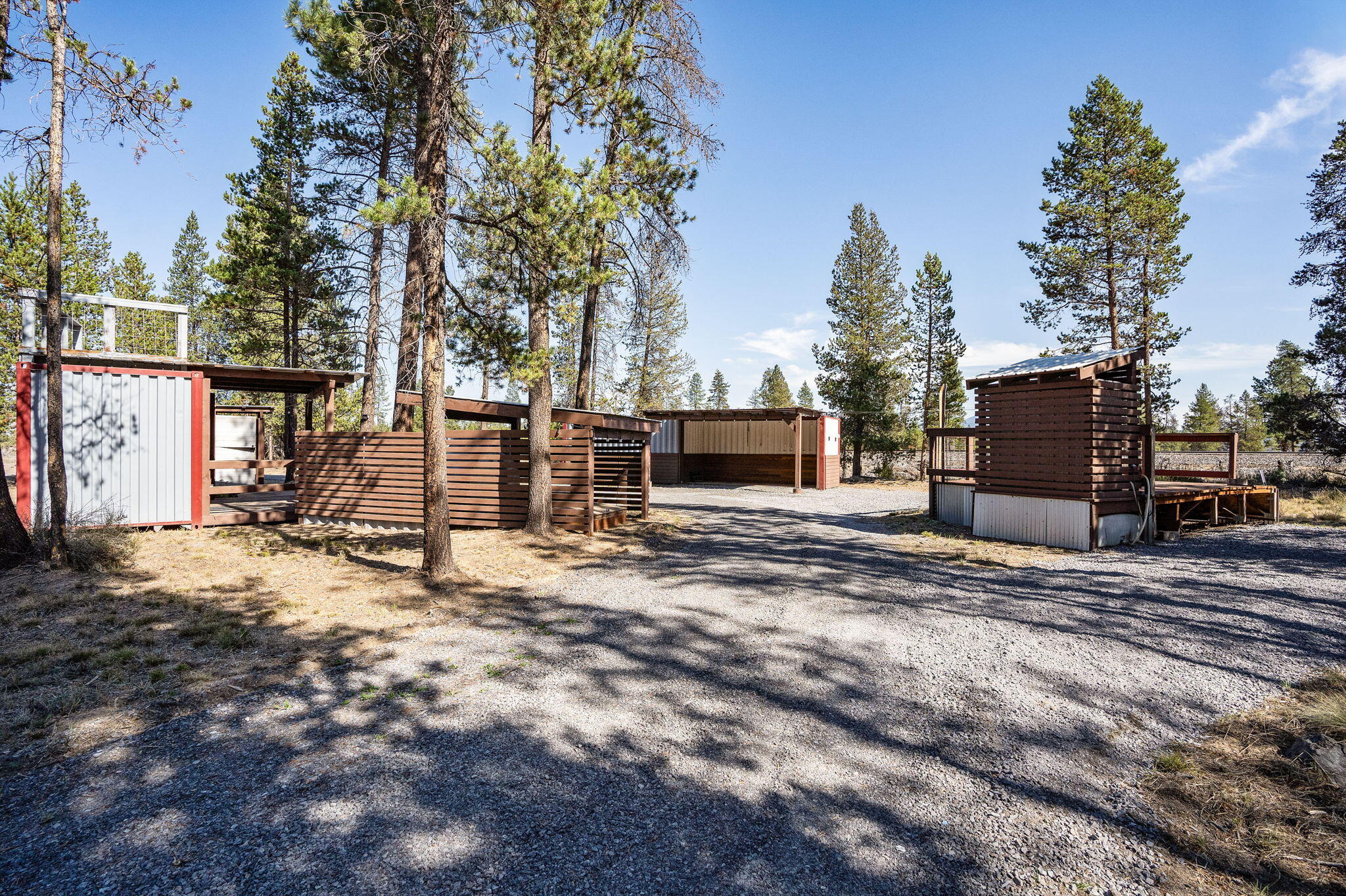 Central Oregon RV property for sale! This well-maintained pull-through lot accommodates RVs of any size, with an on-site RV available for a true turn-key getaway (inquire for details). Perfect for a vacation spot, seasonal living, or investment property, the site is designed for outdoor living with a covered kitchen, bar, & seating areas plus an elevated viewing deck. A converted container provides an open double garage, secure storage, & vent ports for large-scale BBQ. The expansive deck includes an outdoor shower & holding tank for extended stays. Additional features include an on-site well with stainless steel holding tank, power available for RV hookup, graveled areas, & partial fencing. Convenient location with easy access to Hwy 97, just minutes from shopping, dining, the Deschutes River, Mt. Bachelor, lakes, trails, hot springs, snowshoeing, fly fishing & all the best Central Oregon recreation.