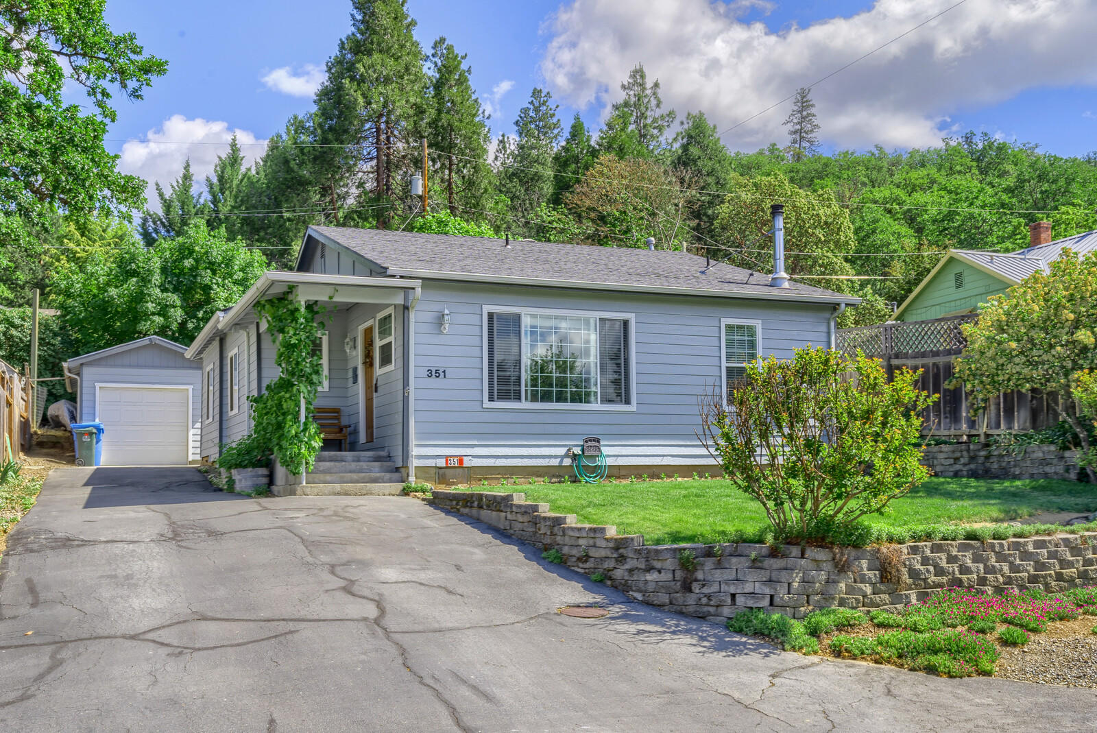 This adorable home built in 1913 has been tastefully updated. Features include open living room with certified wood stove; kitchen with breakfast bar, dining room, Formica countertops, newer appliances, nice cabinetry; laundry room, 2 bedroom; 1/1/2 baths. The back yard is fenced, has a water feature, covered back porch. The front yard has a garden area. Great curb appeal! Plus there is a detached garage. This home is located in Gold Hill on quiet street and is move-in-ready!