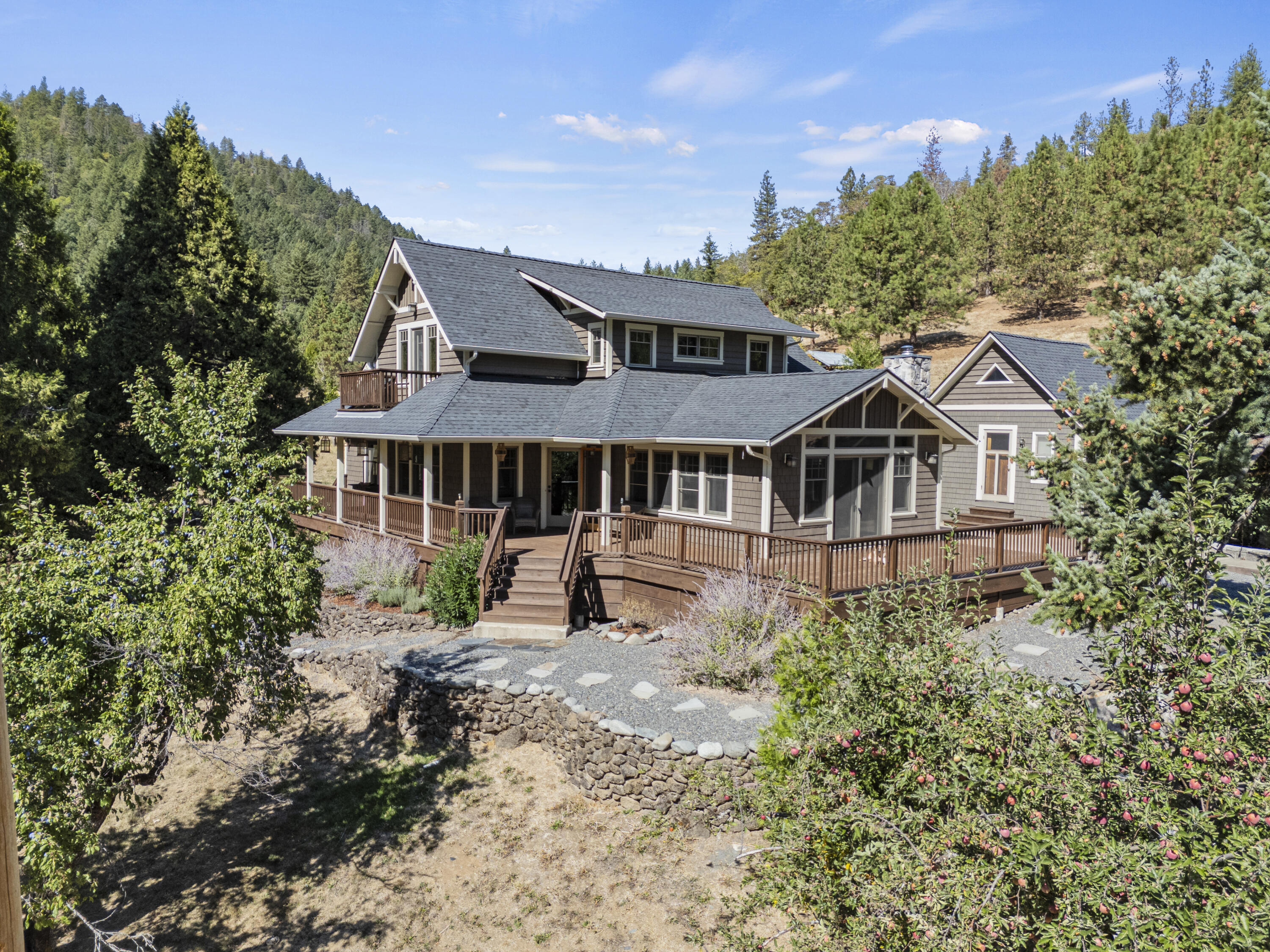 Privacy meets quiet living on this serene 9.48-acre property! High-end finishes are spread throughout including maple, fir, & slate floors. A kitchen island, lots of counter space, and cherry cabinets provide all the cooking and hosting space you could ask for. You have not one, but TWO primary suites-one on each level-with walk-in showers with heating floors and a walk-in closet. With a den, family room, detached office, and another bedroom upstairs. The views from your deck and private balcony off of the second primary suite upstairs are breathtaking. Relax on covered porches or tend to the three garden areas & fruit trees equipped with a drip system. A large detached 888 sq ft shop with power, a barn, chicken coop, and a 2-car garage have your outdoor and storage needs covered. All of that, and a new roof was just installed on the home in July! All that's left is to make this house your home, book your tour today.