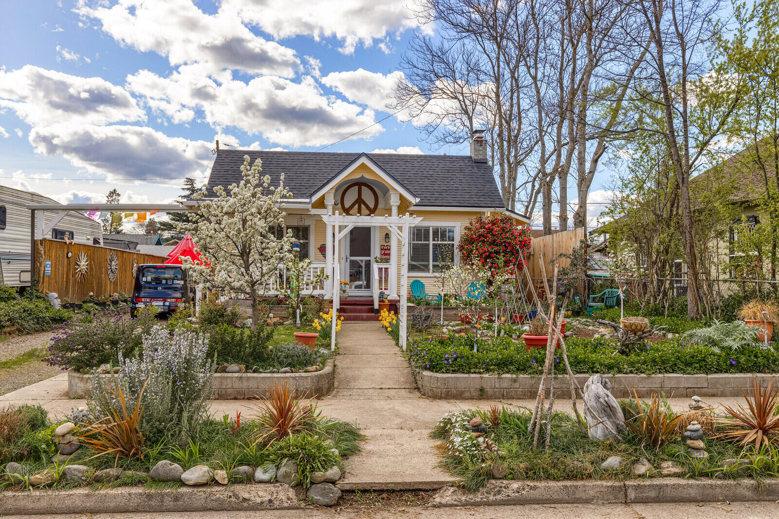 Adorable, cozy & charming home! This 1920's craftsman is 1264 sq feet, 2 bdr 1 bath with a small office area and has been beautifully updated with an open kitchen, granite counter tops, an island and a ton of storage. With a bright & sunny disposition, hardwood floors throughout, tall ceilings, large windows and an open feeling floorplan this home is wonderful place to keep your indoor plants happy as well as enjoying a cup of morning coffee in the dining room window seat. The bathroom has been nicely updated with an oversized tile shower, new vanity and flooring. Outside is a gardeners delight with raised beds, plants, flowers & trees. In addition, there is potting shed and a ''Music Cave'' both structures have power. The Music Cave would make a great studio ADU (check with city of Medford for permitting and uses). New exterior paint, roof and HVAC system 2019. This is a must see home!