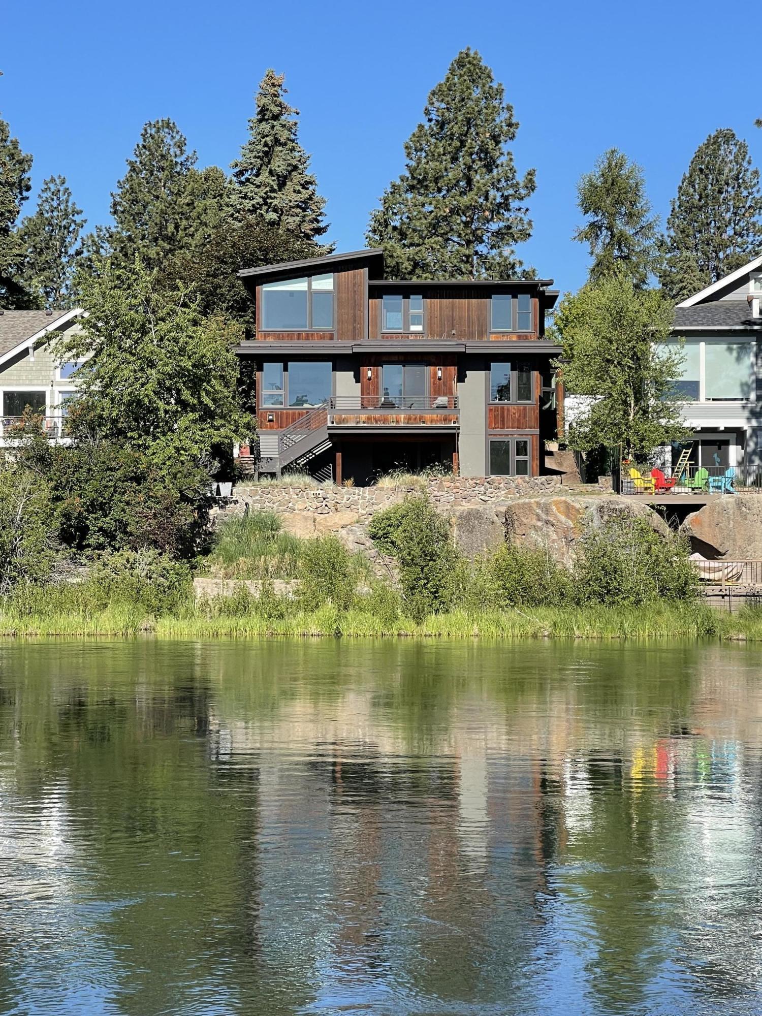 Riverfront living awaits you in this modern Duey Brothers built custom  home with direct river access & panoramic river views. Within a few blocks you'll find the vibrant Galveston corridor, Drake Park & downtown Bend. 1 block to the south is Columbia Park with footbridge access over the river to Deschutes River trail, Miller's Landing Park, White Water Park & the Old Mill. Earth Advantage Platinum certified with grid tied 12 panel PV solar electric & a solar hot water system.  Highly efficient & durable 2x8 staggered stud & ICF construction. Hydronic radiant floor heat throughout lower level. View deck with stairs to the lower level covered patio & meandering path right to the banks of the Deschutes. Spacious home includes 4 beds, upstairs gathering area, generous lower level bonus room & 500 sq. ft. of unfinished storage (not included in sq. ft.) including gear room with exterior & interior access.  Unbelievable opportunity to own this incredible riverfront home in the heart of Bend!