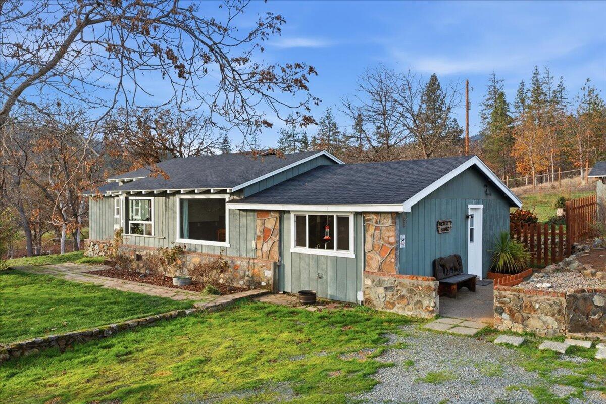 This lovely property has so much to offer! This ranch style home is 2541 SF and has 5 bedrooms and 2 bathrooms. It additionally features a family room, living room, and dining area. The kitchen is spacious with abundant cabinetry. Recent updates include a brand NEW 66X24 2 CAR GARAGE plus shop, newer roof and septic system, newer well house and pump, new electric panel, new ductless mini-split, and a new wood-burning fireplace! Too many updates to list. The home offers garden beds, a private patio area, and an IN-GROUND POOL with new heater perfect for summer fun. The 1.83 acres is completely fenced and gated with plenty of room for animals, this property has the perfect amount of usable land and elbow room. This well-maintained property combines rural living with modern updates and plenty of space for your lifestyle! A drive to Grants Pass takes less than 10 minutes, making this gem of a  property extremely accessible and convenient without sacrificing that country feel.