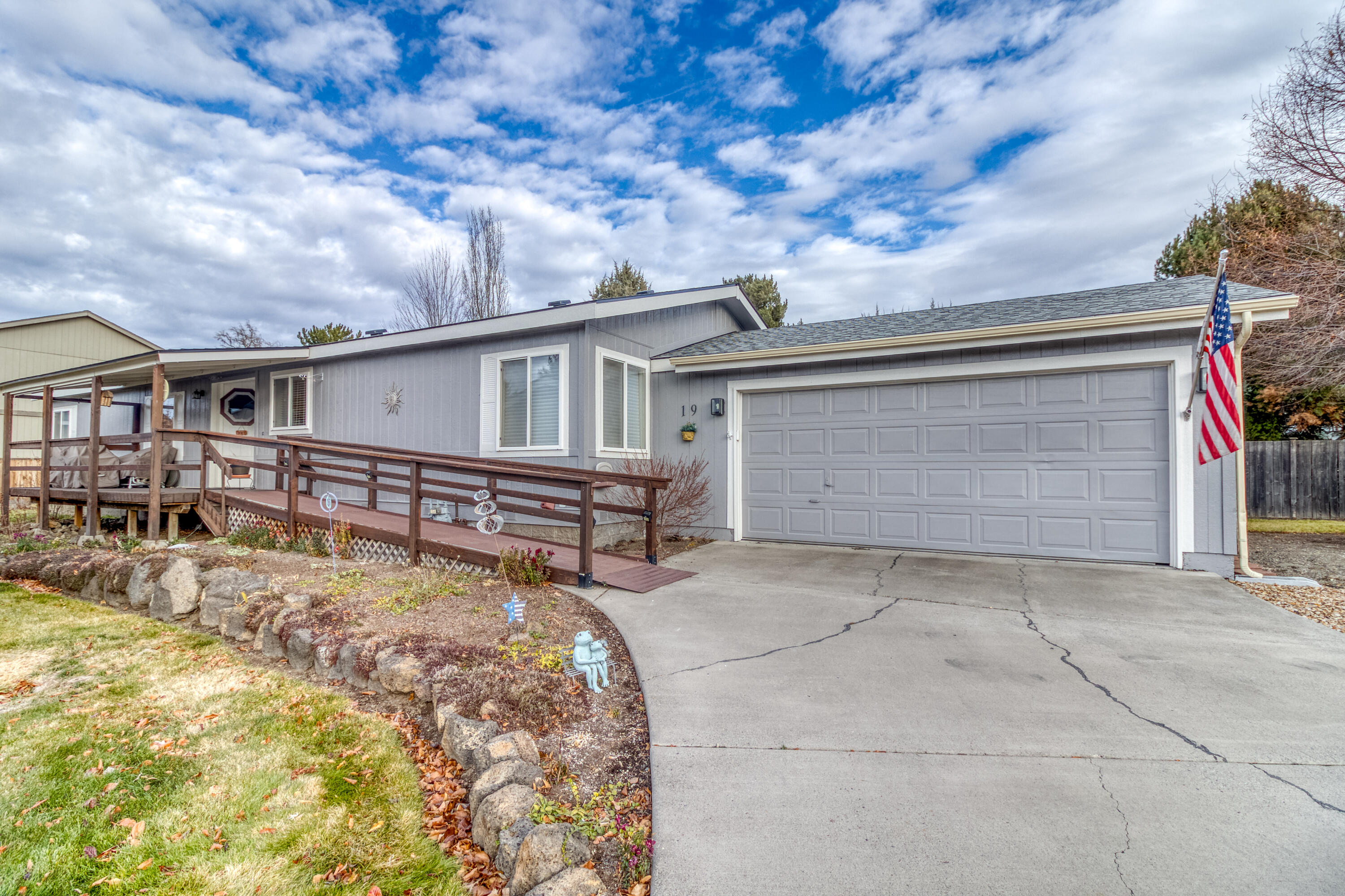 Beautifully updated home in the serene, well-maintained Snowberry Village 55+ community. On a private corner lot at the back of the park, this home offers an open, light-filled layout with numerous updates- new appliances, fixtures, water heater, HVAC, LVP flooring throughout, and a stylish new kitchen island. Roof was replaced in 2021. The new slider brings in abundant natural light and provides easy access to the partially fenced back deck, patio, and spacious yard. Accessibility is thoughtfully incorporated with an accessible tub/shower, a ramp to the front entrance as well as from the heated 2-car garage. Move-in ready, inviting, and located in one of Bend's most cared-for parks just minutes from the hospital, shopping, and restaurants. Community amenities covered in the space rent including water, sewer, irrigation, mowing, waste pickup, snow removal, and use of clubhouse/BBQ area. RV parking with fresh water and dump station offered at only $20/mo to residents as well.