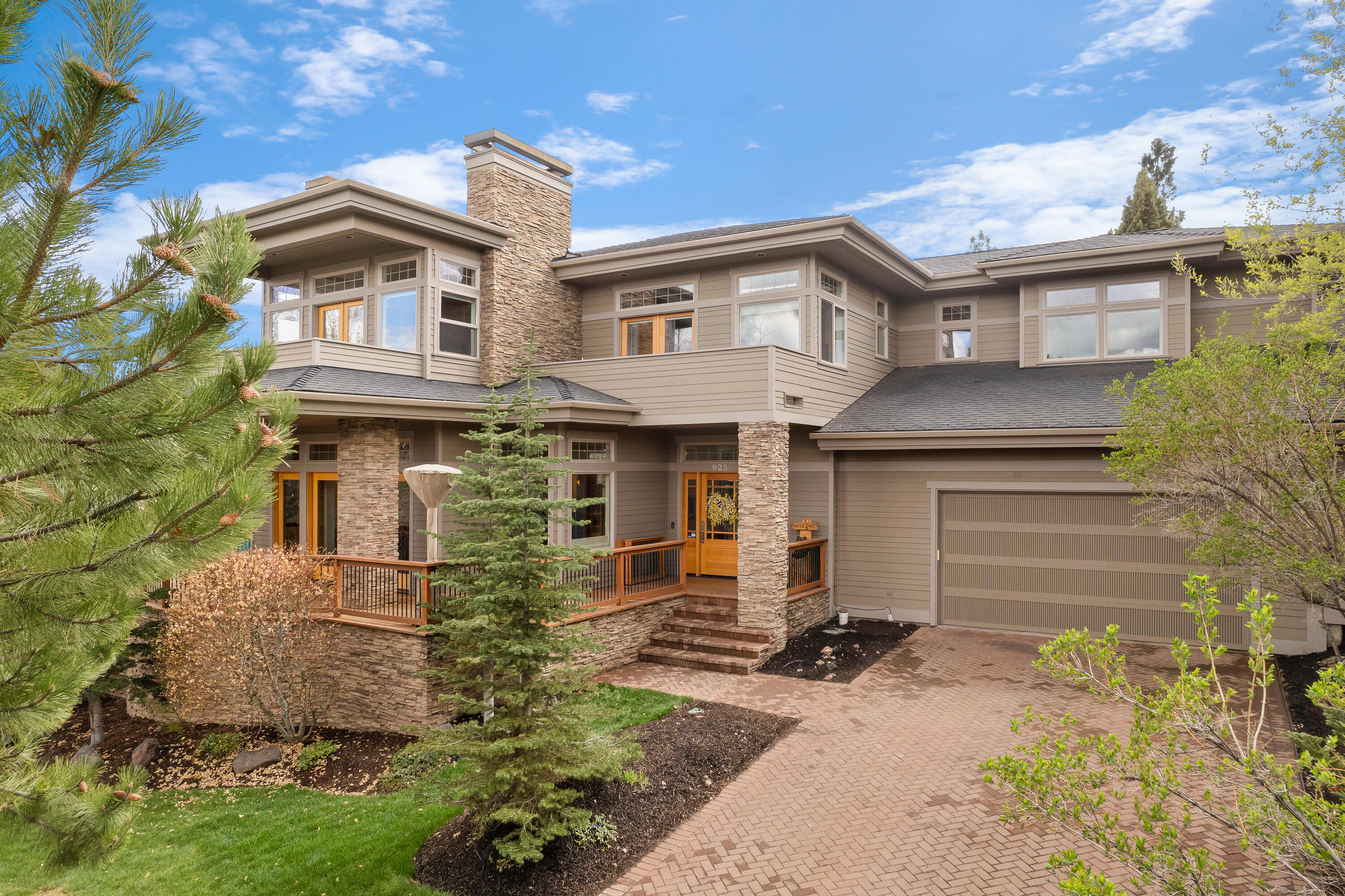 Welcome Home to 925 NW Yosemite Dr! This 4 bds, 5 bth Prairie style home sits on a .23-acre lot with gorgeous easterly views. The downstairs open concept features hickory granite hardwood flooring, radiant in floor heating, central vac and a stunning stacked stone double-sided fireplace. The chef's kitchen has a huge island and wine refrigerator, making it ideal for entertaining.  There are also two separate living areas downstairs, one of which opens onto the patio.  The outdoor oasis has just undergone a massive transformation with all new pavers, landscaping, two firepits to enjoy on those chilly nights and a hot tub tucked away for maximum privacy. This home offers 3 bd suites, one downstairs. Upstairs boasts 2 additional bedroom suites, one of which has a fireplace and private balcony, an office with another balcony, additional bedroom and huge bonus room.  This home has space for everyone and is a short walk to the Deschutes River, trails and Sawyer Park.