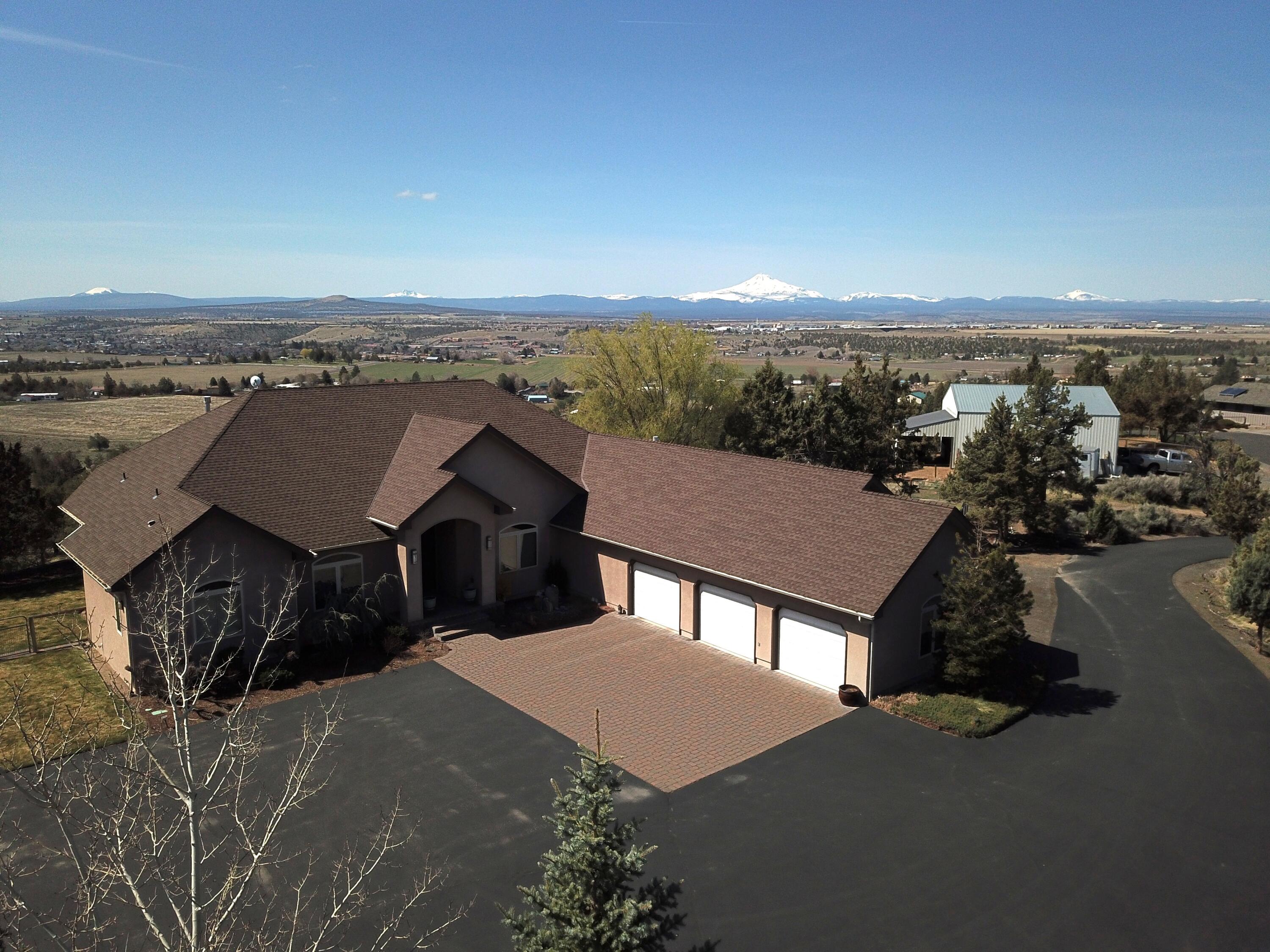 Amazing property w/panoramic views of Cascades & Madras from this hill top property. Custom built concrete stucco exterior w/every up-grade imaginable. As you enter the Foyer, you see straight-on views of the 3 Sisters & the Valley. Living room, Formal dining room and custom office are in view as well. With a total of 3300sf, 4 Bedroom, 2.5 baths, chef's kitchen, kitchen nook, wet bar, custom wood built-in wall in the greatroom & remarkable Primary Suite, this home provides comfort, style & usability. The unique chef's kitchen w/raised L-shaped breakfast bar, Granite counters, under cabinet lighting, SS appliances, hand-made solid wood custom cabinets, + separate wet bar for entertaining & 3 Sisters views Travertine floors---just to name a few outstanding features. The unmatched quality and usability of the Primary Suite is remarkable. Truly a ''must see!'' Please refer to the attached Amenities Sheet for details. Call your favorite agent to arrange a viewing of this rare opportunity.