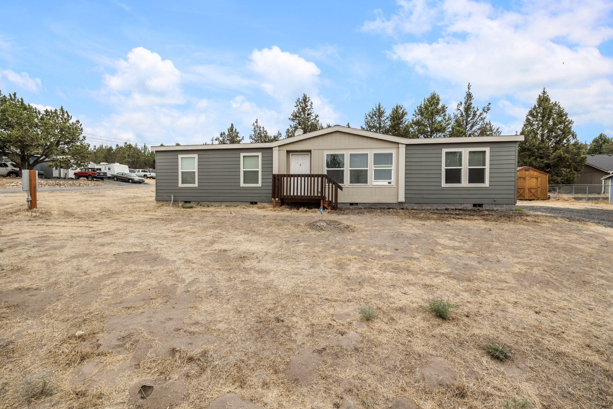 Don't miss this like new home in the quiet Ochoco West subdivision. Open floorplan layout w/ spacious carpeted living area featuring tons of natural light. Kitchen features laminate flooring, plenty of counter space, open eating area, pantry, dishwasher, oven, microwave, & refrigerator. Laundry room is adjacent to the kitchen. Oversized primary bedroom features carpet w/ large primary bathroom & walk in closet. All other bedrooms are large w/ carpet & share an additional large bathroom area. Outside you'll find you have plenty of room for parking & all of your toys plus a shed for storage. Enjoy all the inviting amenities Ochoco West has to offer; including a clubhouse, swimming pool, horse stables, rifle ranges, fishing, & access to over 1200 acres of private land.