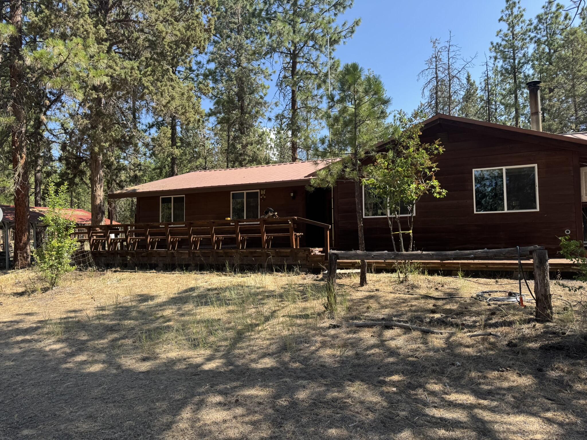 Looking for a quiet setting w/ room for toys or animals? Here it is! This large home sits on 40 acres of serene beauty! Enjoy coffee or tea on the front, or for those cold winter nights, sit in the living room nestled around the warm fireplace! This place has room for it all w/ 3 bedrooms & 2 full bathrooms, & a very large bonus room that used to be a hot tub room, now used as a workshop! The large breezeway/carport offers ample parking or RV/boat storage! Outbuildings & a large 2 bay shop for all your needs! Come see everything this place has to offer today!