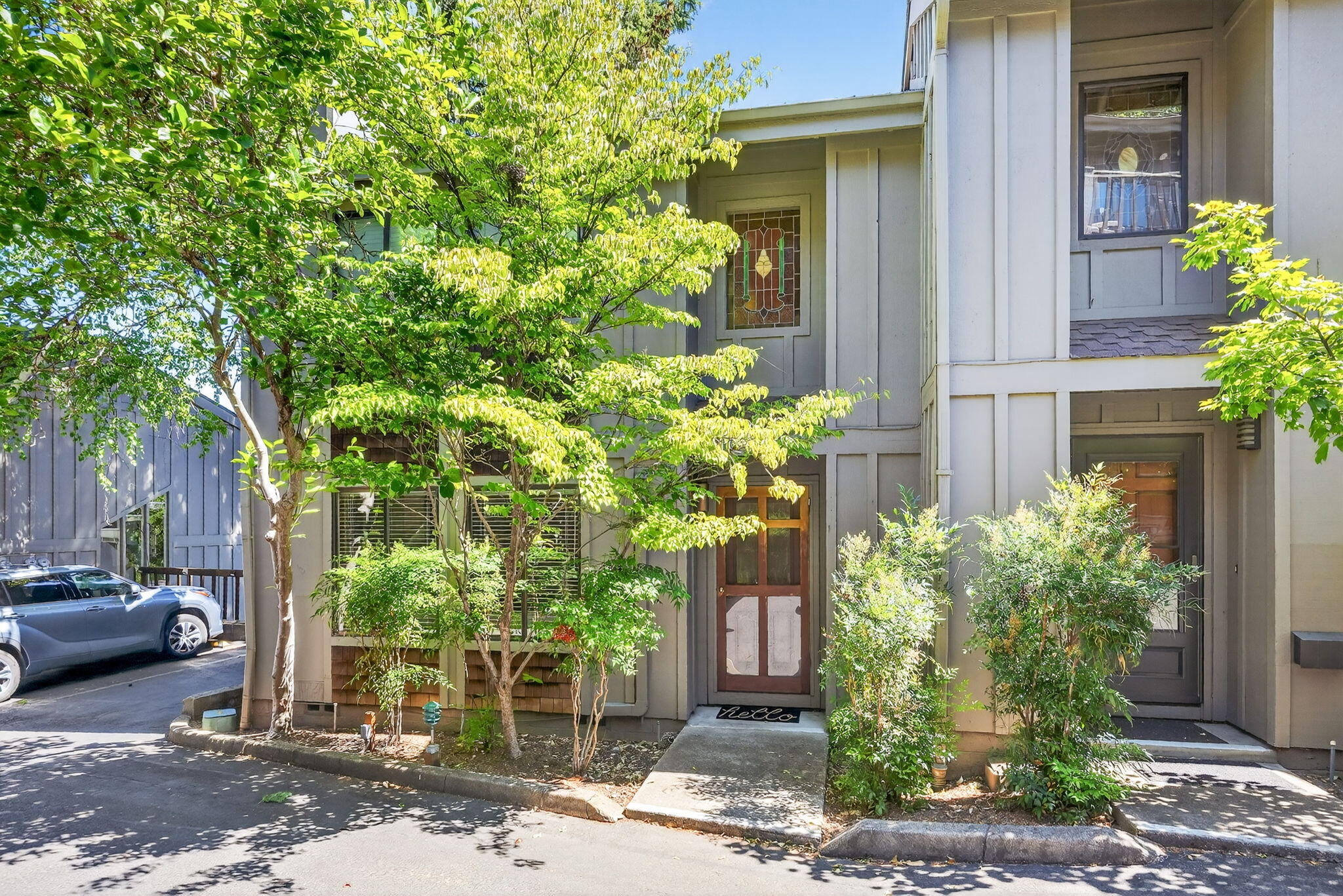 Enjoy the best of Ashland living in this fantastic end-unit townhome at Ravenwood, just blocks from downtown's shops, restaurants, OSF, and Lithia Park. With views of Grizzly Peak and a flexible, light-filled layout, this home is designed for easy, low-maintenance living. The inviting living room offers a cozy gas fireplace and built-ins, while the kitchen and dining area flow perfectly for gatherings. A bonus family room opens to a serene deck— ideal for relaxing or entertaining. Upstairs, two vaulted ceiling bedrooms feature a spacious primary suite with a walk-in closet and a private balcony, offering a stunning view. Covered parking with storage adds convenience. HOA amenities include a pool, landscaping, exterior maintenance, water (interior and exterior water usage), sewer, and trash/recycle removal— a fantastic opportunity to enjoy a vibrant Ashland lifestyle with comfort and ease.