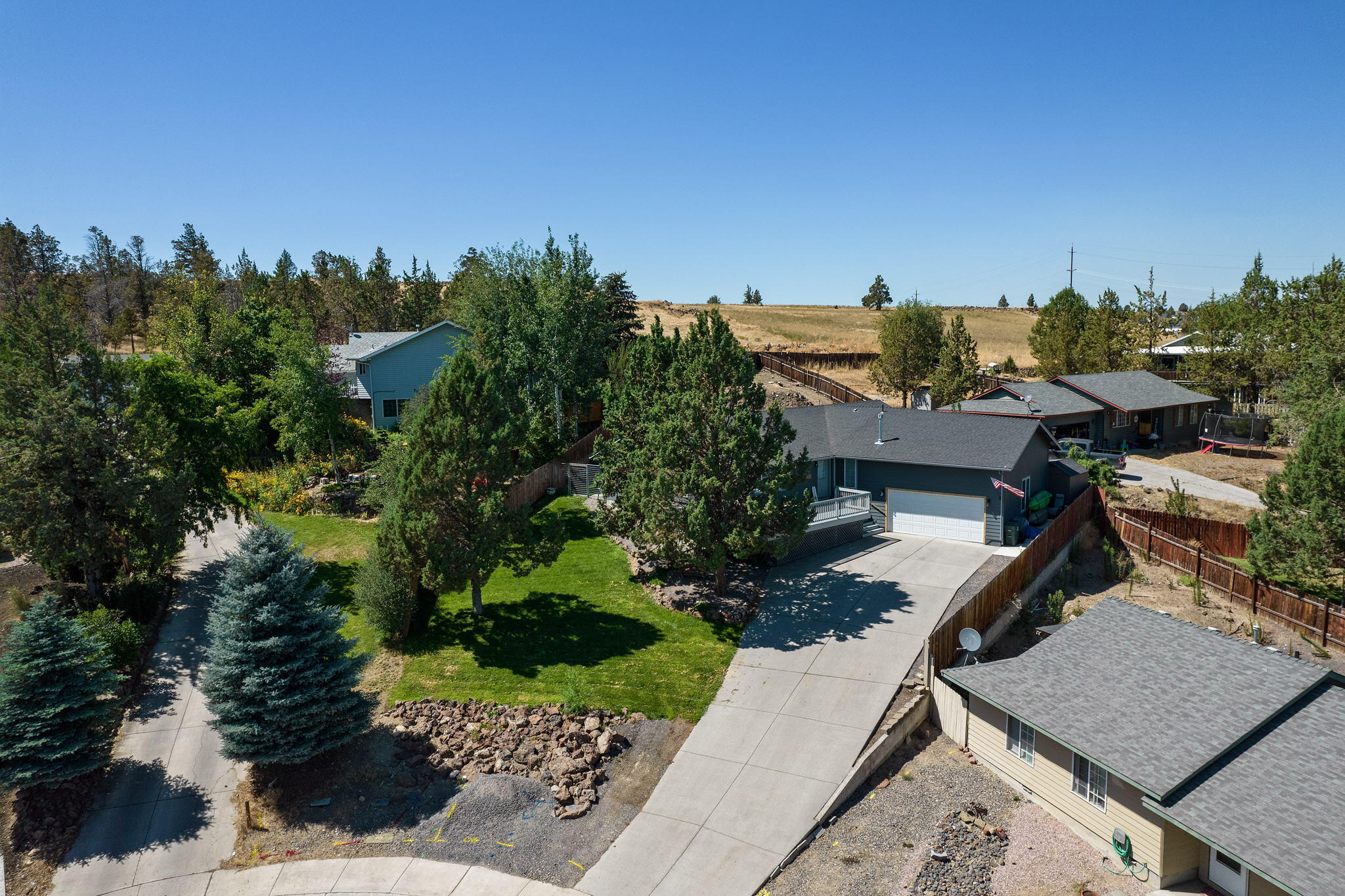 Located on the south end of town, for easy access to Hwy 97, the Jefferson Co. Fairgrounds and amenities of Madras. Home sits at the end of a quiet Cul-de-sac and is situated on an oversized .31 acre lot. Upper part of backyard is prepped and leveled for your Greenhouse, She-Shed, or plenty of other possibilities. Auto sprinklers in front and rear with side yard access. The generous front deck captures the skyline to the east, sure to paint the sky with gorgeous sunrises to take in with a cup of coffee. Bring your family and enjoy an open, bright and light single-level floorplan. A fabulous starter home, rental or investment at the right price in desirable Central Oregon. 26 Miles to Lake Billy Chinook and 28 miles to Redmond Airport.