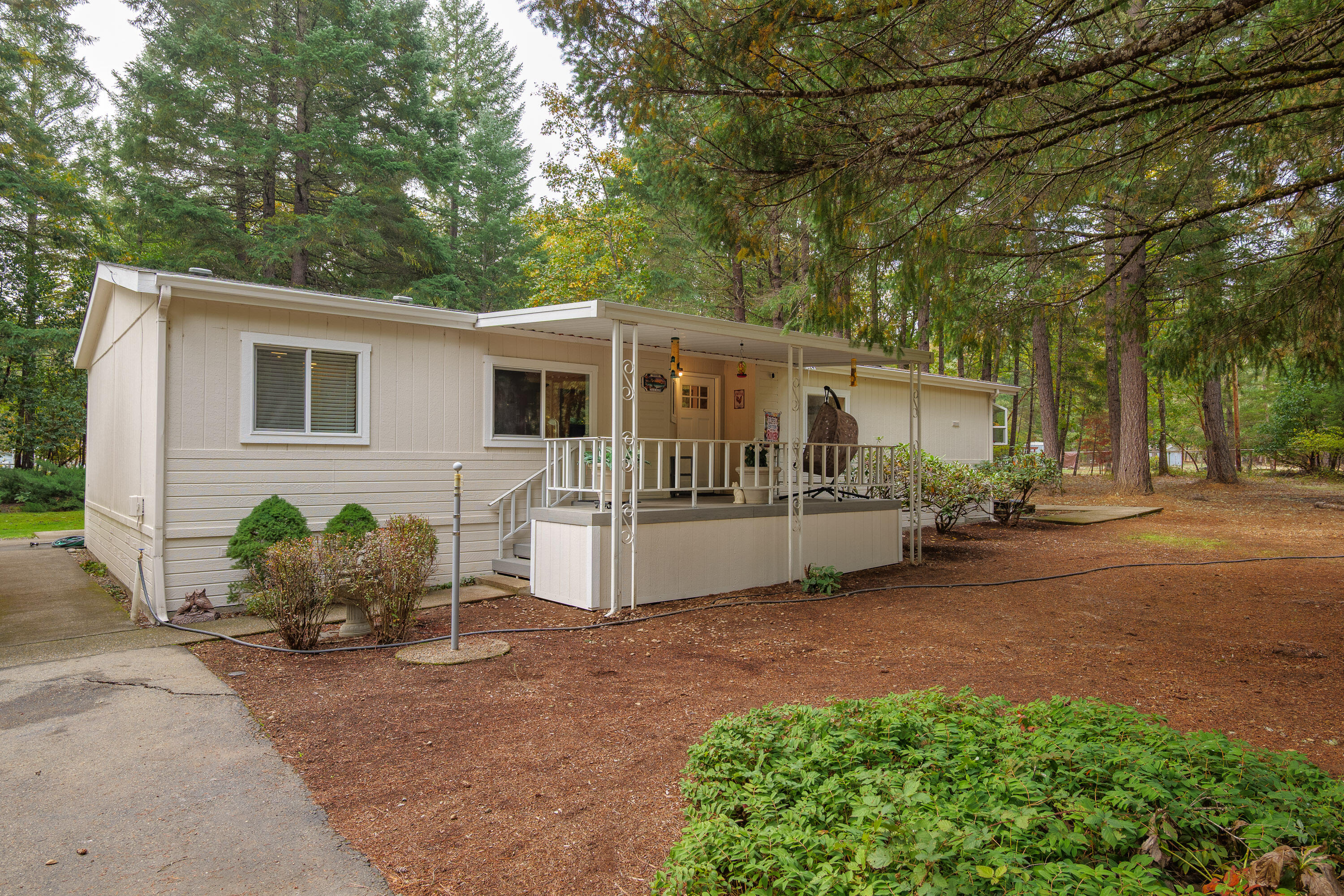 Discover the perfect blend of comfort and country living at 145 Griffin Road in Grants Pass. This beautifully remodeled 3-bedroom, 2-bathroom home sits on 2.5 acres and offers 1,566 square feet of open, light-filled living space. Updates include new flooring, windows, doors, and a freshly painted exterior. The kitchen features tile countertops, while both bathrooms shine with granite and modern finishes—the primary showcasing a double vanity. Outside, enjoy a large garden with a sturdy deer fence, new Tough Shed, chicken coop, outdoor pantry, and new water filtration system. A detached 2-car garage/shop and carport provide plenty of space for parking and projects. A move-in ready property designed for relaxed rural living close to town.