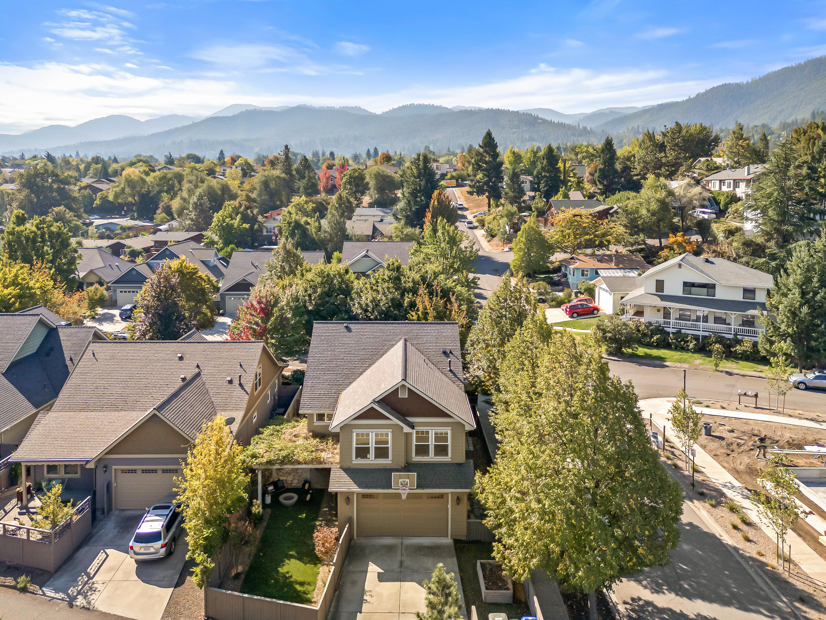 Welcome to this beautiful 3-bedroom, 2.5-bathroom home on a corner lot in one of Ashland's most desirable neighborhoods, just a short walk to North Mountain Park. Offering over 2,200 square feet of living space, it features tall ceilings and an open floor plan that create a comfortable sense of space. A gas fireplace adds warmth to the living room, while the kitchen is highlighted by stainless steel appliances, gorgeous tile countertops, and a stylish backsplash. The primary suite upstairs provides a private retreat with its own deck, walk-in shower, jetted soaking tub, and spacious walk-in closet. At the top of the stairs, a charming reading nook offers a cozy spot to unwind. Outside, the backyard is designed for low-maintenance enjoyment with turf, simple landscaping, and a gas fire pit perfect for entertaining or relaxing. Combining comfort, function, and location, this home captures the best of Ashland living.