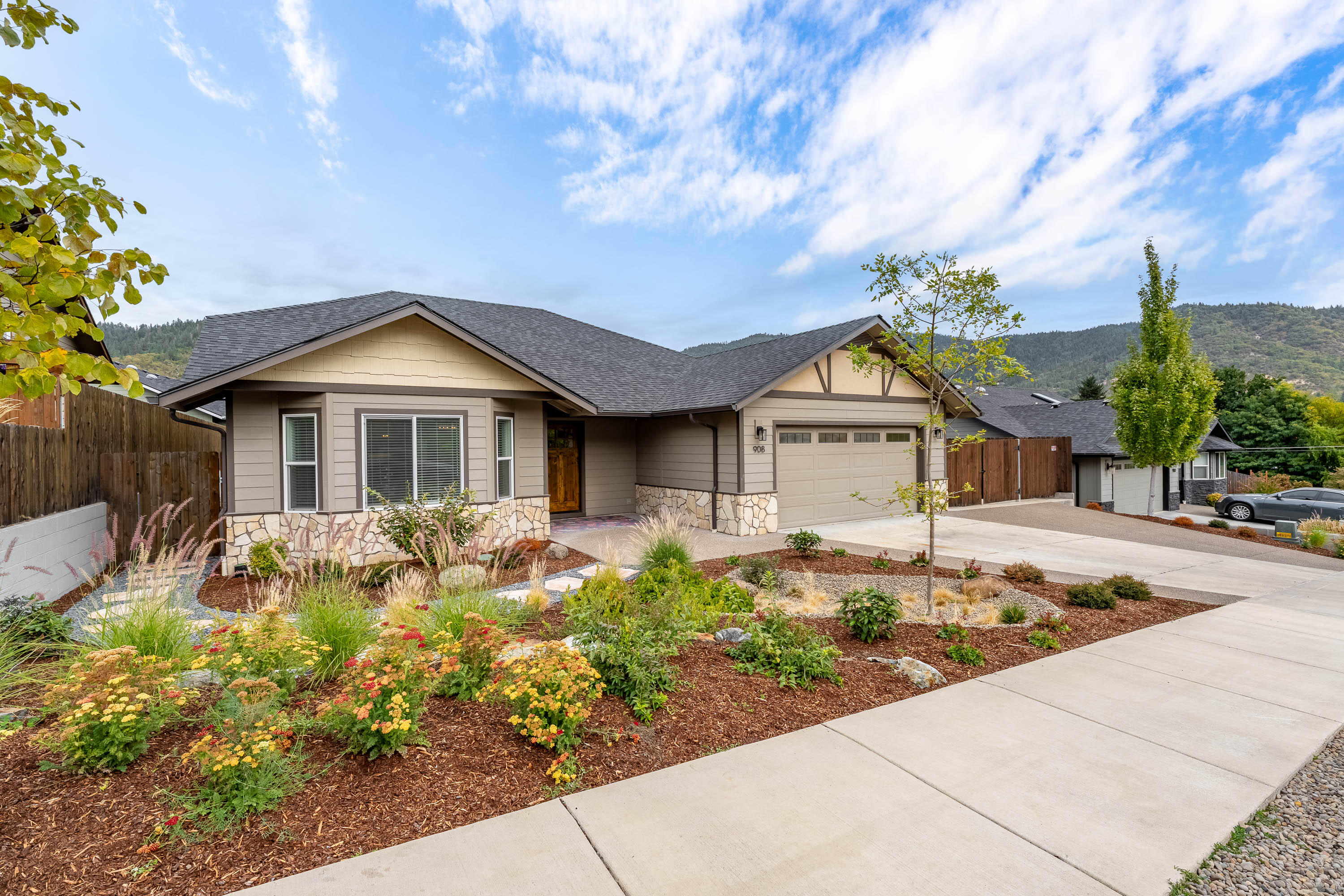 Built in 2020, this single-level home is located in one of the most desirable, newer neighborhoods of NW Grants Pass. Offering nearly 2,000 sq ft of well-designed living space with vaulted ceilings, real hardwood floors, with a stone gas fireplace as the centerpiece. The kitchen features striking granite countertops, stainless appliances and a large island ideal for gatherings. The split-bedroom layout provides privacy for the primary suite with a walk-in closet and tiled shower, with two additional bedrooms and a full bath. Outside, enjoy a beautifully re-landscaped backyard with a large paver patio, custom water feature, and low-maintenance design. Additionally outside, enjoy the covered patio, and concrete RV parking with sewer dump and water hookup, and 30-amp plug-in. The garage utilizes a new Mini-Split for year-round comfort. Conveniently located near schools, shopping, and downtown, this home offers comfort, quality, and modern style in a move-in-ready package.