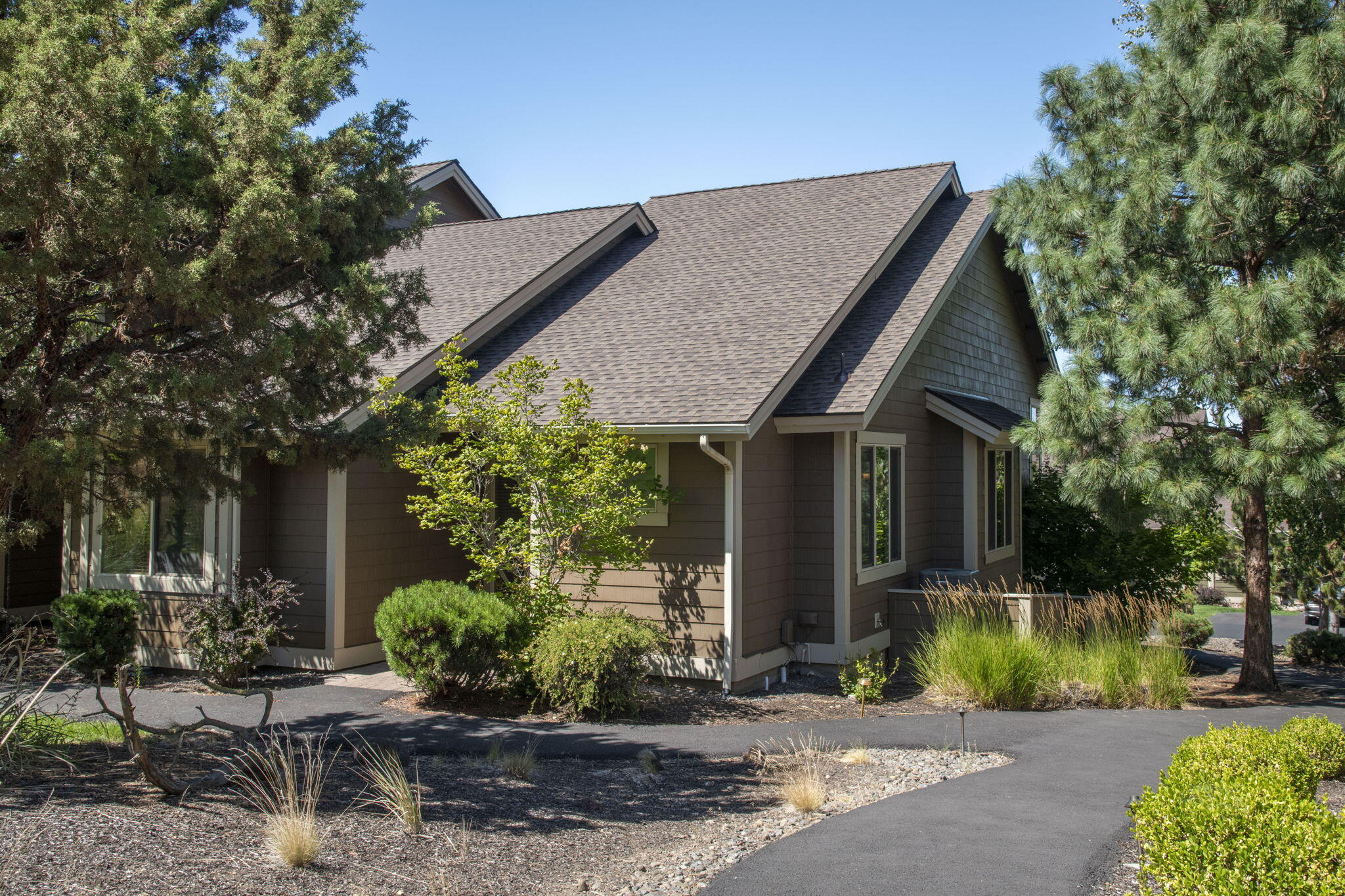 MOTIVATED SELLERS!  Take a look, make an offer! My clients are ready to go and so is this property.  Move-in ready with this effortless single-level townhome.  This 1,419 sq ft end-unit with 2 bedrooms and 2 bathrooms in Eagle Crest Resort boasts vaulted ceilings, luxury vinyl plank flooring, a cozy gas fireplace, and abundant natural light. It has a new water heater and HVAC system as well.  Thoughtful storage includes built-ins plus two exterior storage closets. Step outside to an elevated paver patio stubbed for gas grill, perfect for relaxing or entertaining. The townhome comes with 2 dedicated parking spots out front, and plenty of guest parking across the street, making it easy to entertain.  Enjoy resort-style amenities with miles of trails, pools, fitness centers, sport courts, restaurants, and three golf courses just moments away. Ideal as a primary residence, second home, or vacation rental.