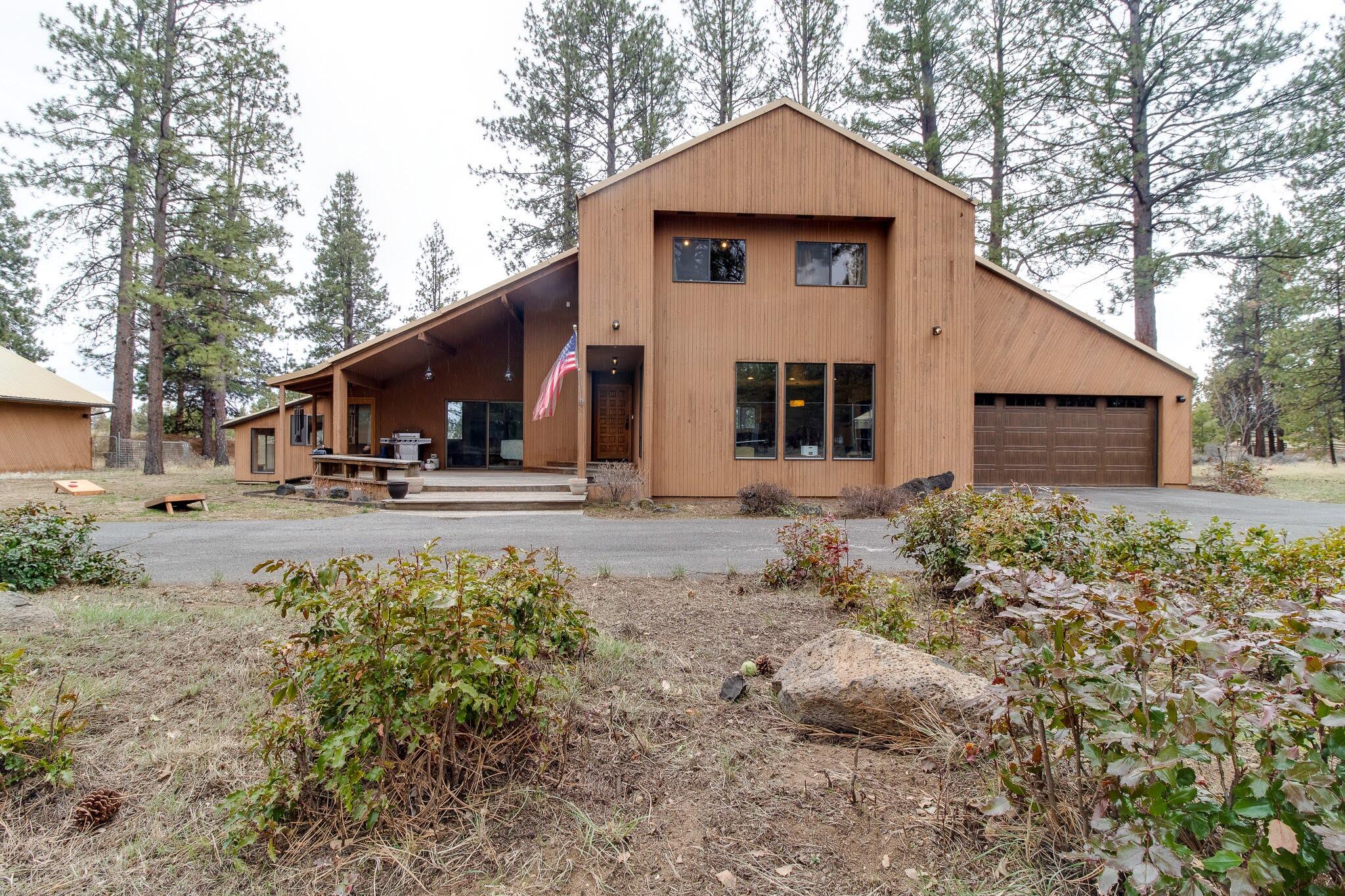 Featuring a newer 5000 sqft hangar w/ an original home nestled on 4 acres of picturesque land, including 2 buildable, +2 common area acres. This property is located in a gated community w/ beautiful mountain, forest & runway views, offering a serene escape w/ access to nature & a runway. This home spans approx 2800sq ft, boasting 3 bdrm, 4 baths. Offering a spacious living room, a cozy family room w/ large wood burning stove & an open remodeled kitchen & dining room. Upstairs the primary bdrm boasts a balcony w/ views of the magnificent Sisters Mts & an en suit bthrm w/ a cedar-lined sauna.  The highlight of this listing is the exceptional, recently constructed hangar, measuring an impressive 48x104' w/ 16' ceilings, offering immense value & versatility. Currently accommodating 3 combined uses, this well insulated space features a designated airplane area, RV storage w/ double drive-thru doors +1500sqft currently used as large gym area.