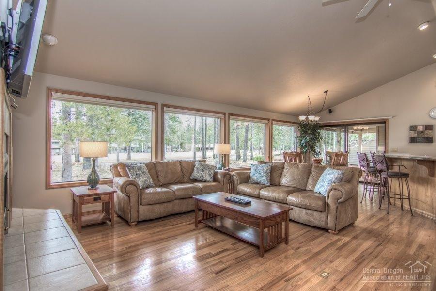 Single-level in a desirable location!! Great views of the 11th Fairway of the Woodlands Golf Course! Centrally-located to enjoy all the amenities of Sunriver. Large picture windows make it light & bright! Open concept floor plan, gas fireplace, vaulted ceilings, skylights, granite kitchen countertops, hardwood floors, tile entry, and guest bath. Nice separation of master suite from junior master and guest bedroom. Features surround sound throughout, hot tub, 3-car garage, and central A/C. Welcome home!