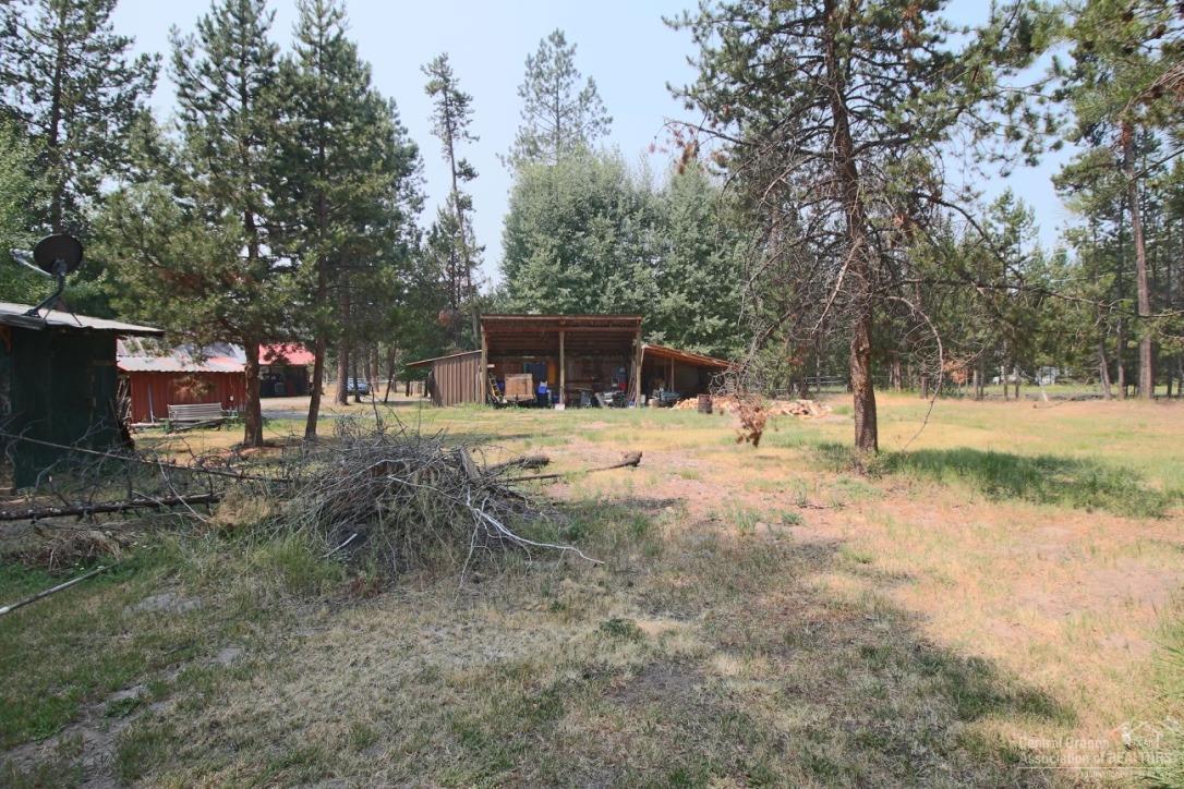 Can you believe a 1,584 square foot home with frontage on Little Deschutes River on almost 6 acres (approx. 5.71 acres) and on a paved road for under $400,000? The location on Lazy River Drive is perfect to for easy access to the lakes, Mt. Bachelor and to Sunriver. There are several outbuildings and a green house to start all your plantings early. Come and see this opportunity to have your own get-a-way. The gorgeous Acacia wood floors were just installed, Hickory cabinets, 2 separate tax lots.