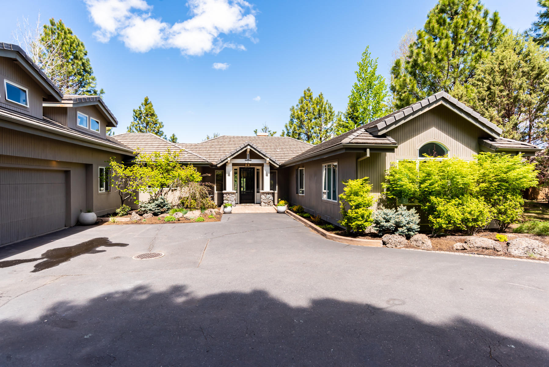 This stunning Sunrise Village home has it all! With mostly main level living, the home has a spacious and airy feel. There are 4 bedrooms (3 on the main level), library, office and large bonus room. The lovely white kitchen has beautiful quartz counters and ample storage. The dining and great room look out onto the private backyard, with trees everywhere! In the great room, enjoy a gracious entertaining space, including a wood burning gas fireplace. You will also see a fireplace in the master bedroom, as well as a large walk-in closet, and generous built-ins. Upstairs, you will find a bonus room, guest room, bath, and full wet bar. Upstairs would make an amazing ADU/mother-in-law suite as this is all located over the large 4 car garage. 
 Outdoor enthusiasts will love all of the storage in the oversized 4 car garage. Neighborhood amenities include: pool, tennis courts, playground, clubhouse, trails, and private beach on the Deschutes river.