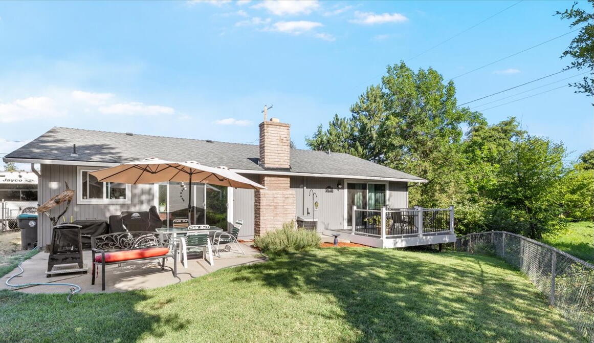 Located in desirable East Medford, this 3-bedroom, 2-bath home sits on a spacious 0.28-acre lot with a backyard that feels like a private park. Enjoy a lush lawn, year-round water and visiting wildlife, plus plenty of space to entertain on the patio and deck. It's a rare outdoor retreat in the heart of town, complete with a utility shed, 30-amp RV hookup, and room to park your toys. Other perks include remodeled bathrooms, a cozy wood-burning fireplace, newer water heater (2023), roof (2019) and carpet. Properties like this are uncommon at this price, an ideal opportunity for first-time buyers looking to settle down in a great neighborhood or for investors seeking a solid return.