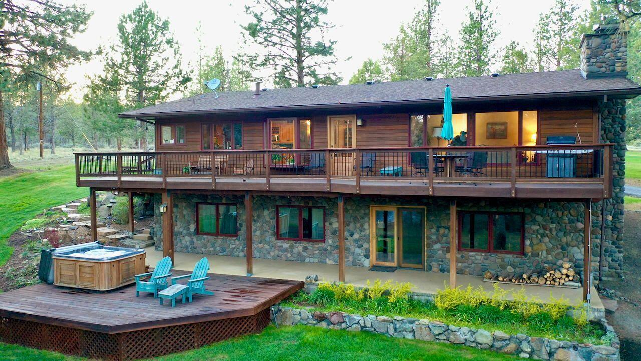Central Oregon waterfront oasis located only 2 miles from downtown Sisters with approx 1200' of accessible Whychus creek frontage. This gracefully updated home has a warm and welcoming feeling featuring a kitchen with locally crafted Port Orford Cedar cabinets, granite and black walnut countertops, and maple hardwood floors that lead into the dining and living rooms which all have unobstructed views to Whychus creek. The master bedroom with spacious en suite, 1 additional bedroom, and full bath are on the main level. The 2 remaining bedrooms, music/craft/spare room, a full bath, and a bonus family room are downstairs and provide ample space for the whole family. 3.5 acres are irrigated, flat pasture land currently in hay production. Efu zoning keeps the taxes low and allows a multitude of farm uses. The estate includes a feeder barn, pole barn and detached garage for all your covered storage or all your farm animal needs.  The listing broker is related to the Seller.