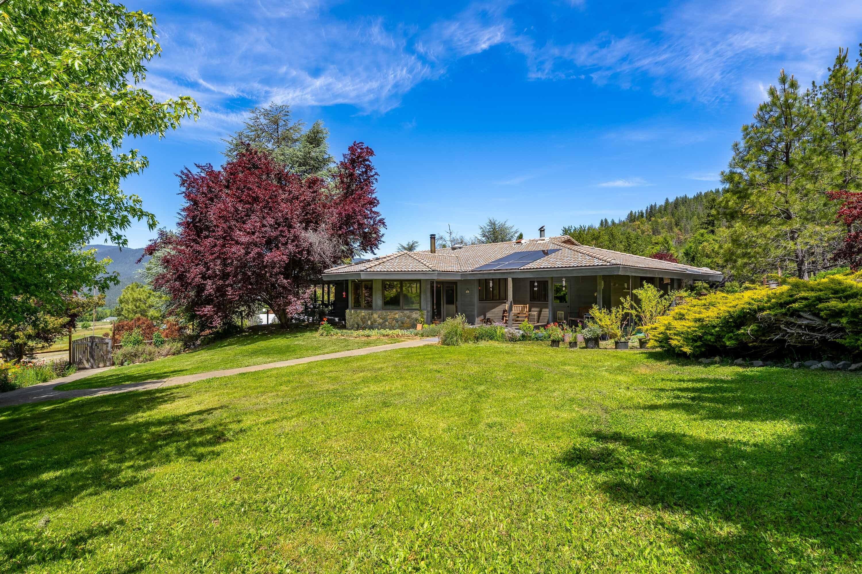 Incredible 50-acre property with panoramic views, ideal for livestock, horses, or homesteading. Features include a high-producing well, solar power, fenced garden, seasonal creek, three ponds, and wooded trails. There is a large pole barn, hay storage, corral, 2-stall horse barn with tack room, 8-stall equipment barn, mechanic's garage with a walk down mechanics pit, and garage/shop with loft and craft room. Land is currently being used for first cutting grass hay production and averages 8 tons a year. Though not certified organic, the land has been kept chemical free for the last 12 years. Frank Loyd Wright inspired 2,440 sq ft main home secluded in landscaped grounds featuring, fruit trees, berries, flowers and shrubs. Property also includes a 3BD/2BA manufactured home, that is currently rented and set well away from the main house for  privacy.
