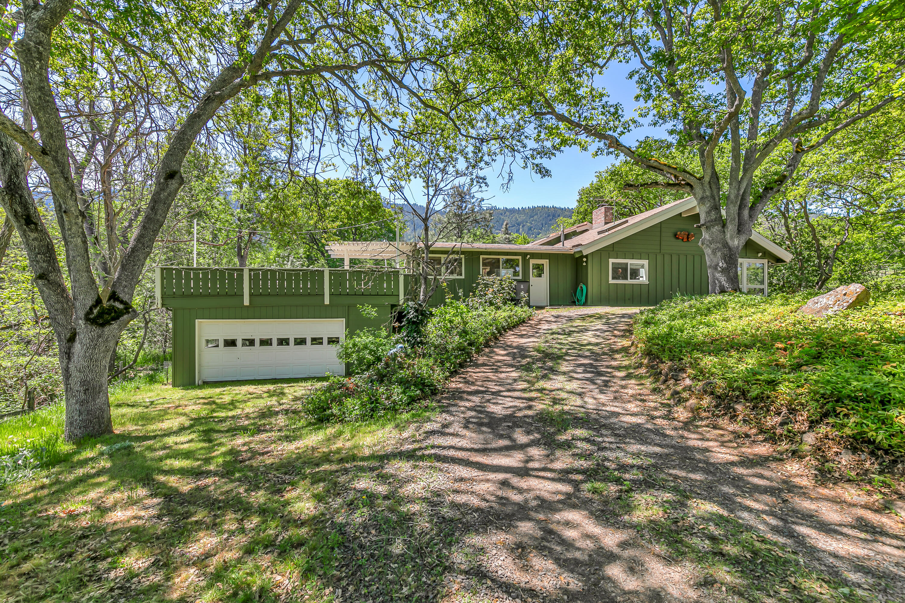 This classic, ranch style home is situated in a prime, close-in rural location surrounded by stunning natural landscape including two ponds & seasonal creek. Vaulted living room filled w/ natural light; a wood stove w/ classic brick surround anchors the primary living space & provides warmth & charm throughout. The functional kitchen is roomy, offering stainless appliances, ample counter & cabinet space, & flows nicely into the adjacent flex space & dining room. The primary suite has a walk-in closet plus ensuite bath w/ jetted tub. Two additional bedrooms + a full bath are also quite spacious. Lower garage has two flex spaces, not included in the SF plus a roof top deck. The land is versatile; fenced pastures, enclosed garden, greenhouse, grapevines, fruit trees + hen house. Included is an additional, 3.1-acre parcel, zoned RR5 w/ its own barn, pasture, & incredible views, offering even more possibilities! *Buyers to do their own due diligence re: building potential on the 2nd parcel