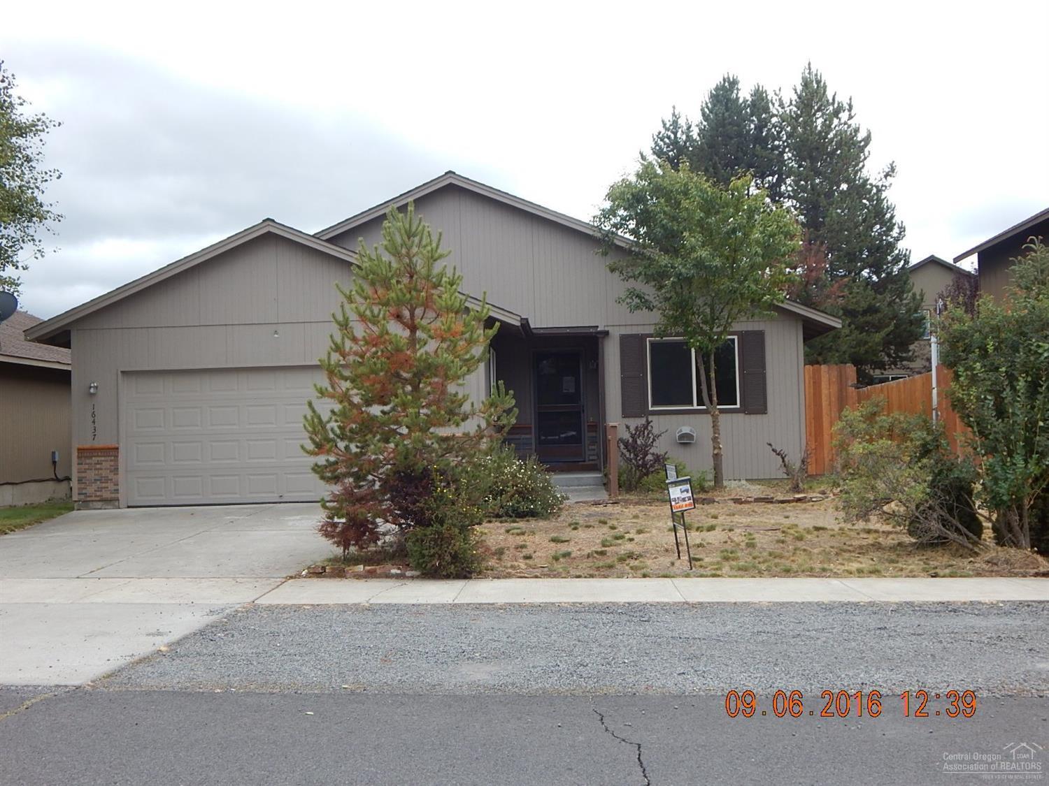 Great value here in this 3 bedroom, 2 bath home with in-town location. Fenced yard with storage shed and deck in back. Attached double garage, great room concept with dining, living room and kitchen in one room. Vaulted ceilings, ceiling fans, and inside laundry area. Kitchen has an island, white microwave, range and dishwasher. Needs some TLC, priced right!