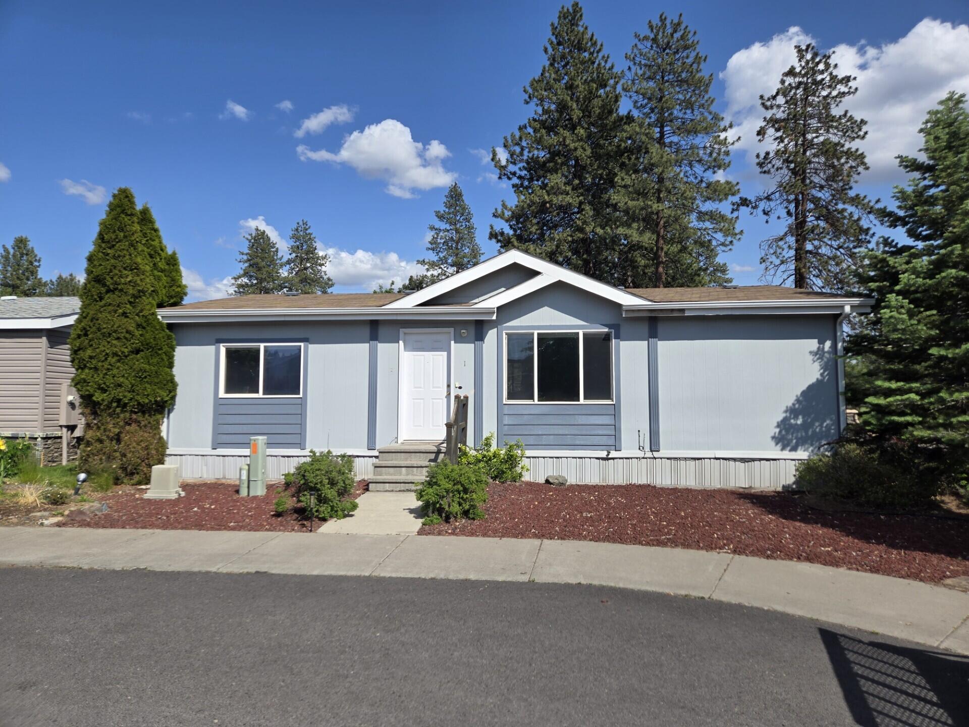 Welcome to the very desirable Golfside Park, where this spacious home sits on a large corner lot, which offers a covered double carport plus 2 additional parking spaces.
Completely fenced backyard w/ a small, covered deck and a storage shed. The home has an open floor plan with separation between the primary suite and the 2 other
bedrooms. The main bedroom has a large closet, ceiling fan, a soaking tub, and a newer vanity. The secondary bedroom has a sliding glass door that leads to it's own deck. The guest bathroom has a walk-in shower. Other upgrades included are, Central A/C, a large country style sink in the kitchen, and a ceiling fan in the living room. The location is great; you have the Bend Country Club right out your back door, close to Markets, lots of shopping and Restaurants, and you have direct access to HWY 97 and all other parts of town! The home is on leased land, so any new owner will need to be approved by the park manager. Financing options available, please CLA.