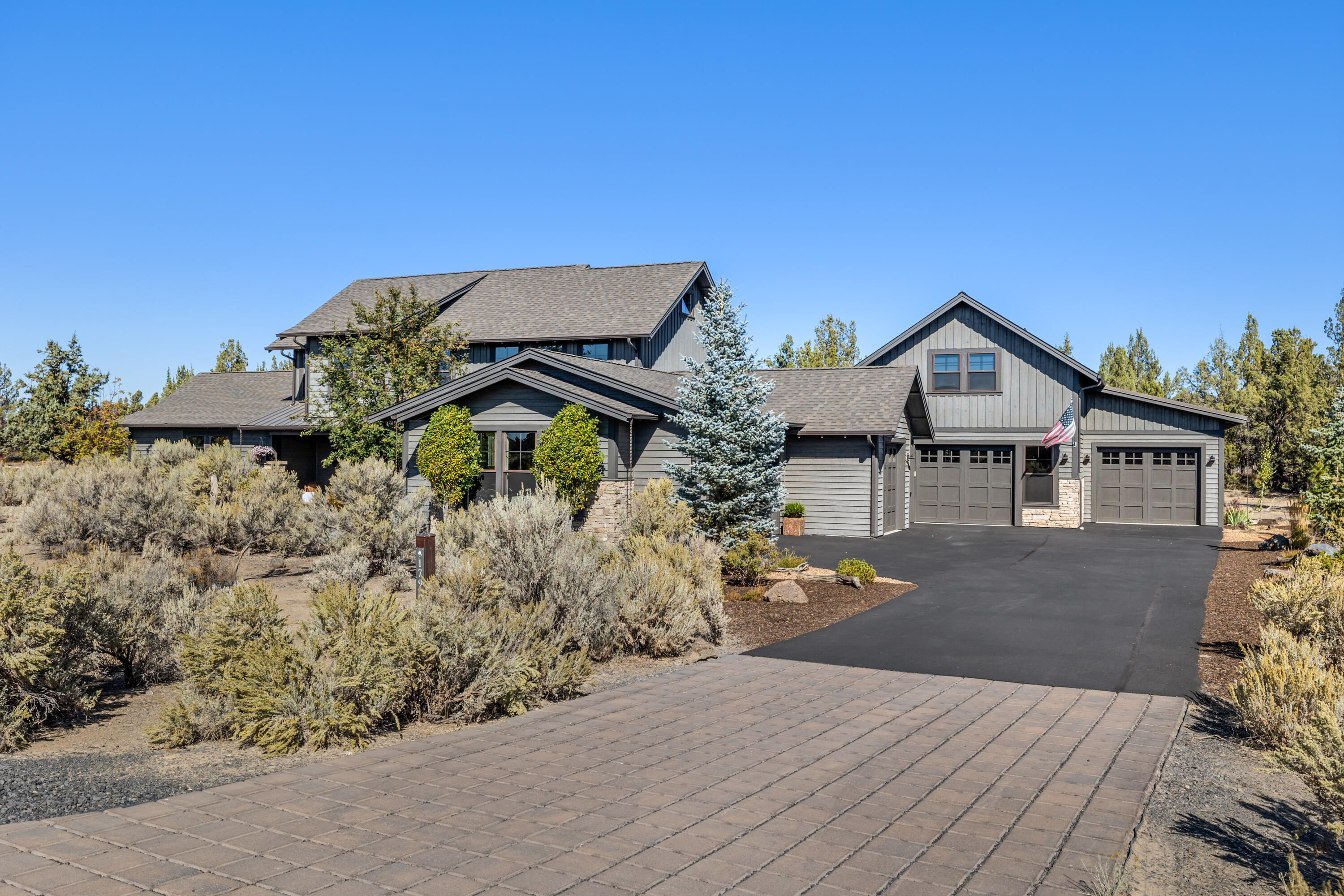 Your next retreat...NW Ranch style home w/custom upgrades throughout backs to the canal common space & access to acres of BLM. Open living area featuring oak hardwood floors, stone fireplace, wood plank accent walls & primary suite on the main. Oversized granite island in the kitchen is a focal point, double freezer/refrigerator w/ custom built in surround. Upstairs media/theatre room has top of the line sound equipment, platform theater chairs & custom cabinetry. The 2019 addition, built by PacWest, features guest space of 917sqft, ADA accessible, w/tile shower, full kitchen, pantry, stackable washer/dryer, & patio. Bonus loft with private office is ~600sqft. 1,200sqft shop, car lovers dream...professionally epoxy floors, built-in surround sound with subwoofer, led lighting, half bath, & upstairs craft room/gym w/private office. Enjoy the amenities of living at Brasada Ranch: 18 hole golf course, restaurants, miles of trails, equestrian center, 3 pools lazy river, slide, spa, & more.
