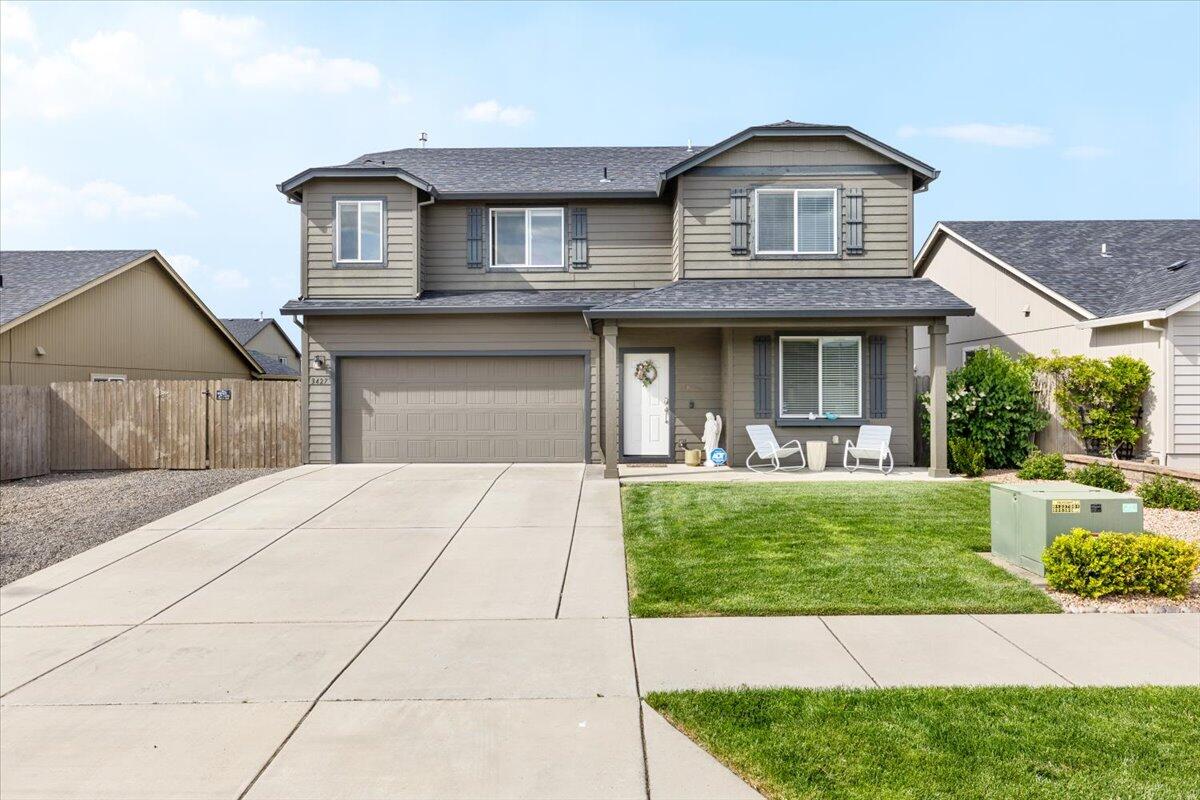Don't miss this beautifully appointed 5-bedroom, 2.5-bath home with 2,192 sq. ft. of thoughtfully designed living space. The open-concept floorplan is filled with natural light and showcases premium details throughout, including stone countertops and custom tile backsplashes. The main level offers a bedroom with generous storage, spacious family and dining areas, and a gourmet kitchen with ample counter space, abundant cabinetry, large pantry, and premium finishes. The living room centers around a cozy fireplace and opens to a covered patio and expansive fenced backyard—larger than most in the area. Upstairs, the primary suite features a spa-inspired ensuite with dual vanity, soaking tub, walk-in shower, private water closet, and oversized walk-in closet. Three additional bedrooms, a full bath, and dedicated laundry complete the upper level. With an attached garage, ample parking, and stylish finishes, this home truly checks every box!