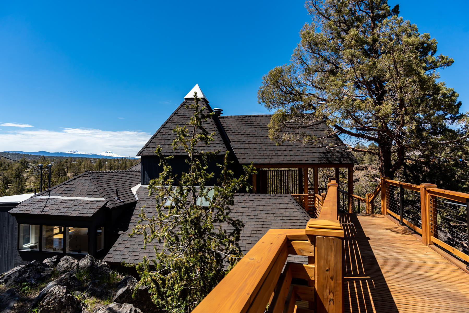 Rare opportunity to own this amazing home overlooking the Deschutes River surrounded by unique rock outcroppings and sweeping Cascade mountain views. Listen to the sounds of the river from almost every room in the home creating a tranquil and peaceful setting  to enjoy. The architectural design of this home, on 1.48 acres, creates a feeling of airy openness at the edge of the world. Private master suite features a custom tile steam shower, walk in master closet and private desk. Kitchen features SS appliances, quartz countertops, large island and ample storage.