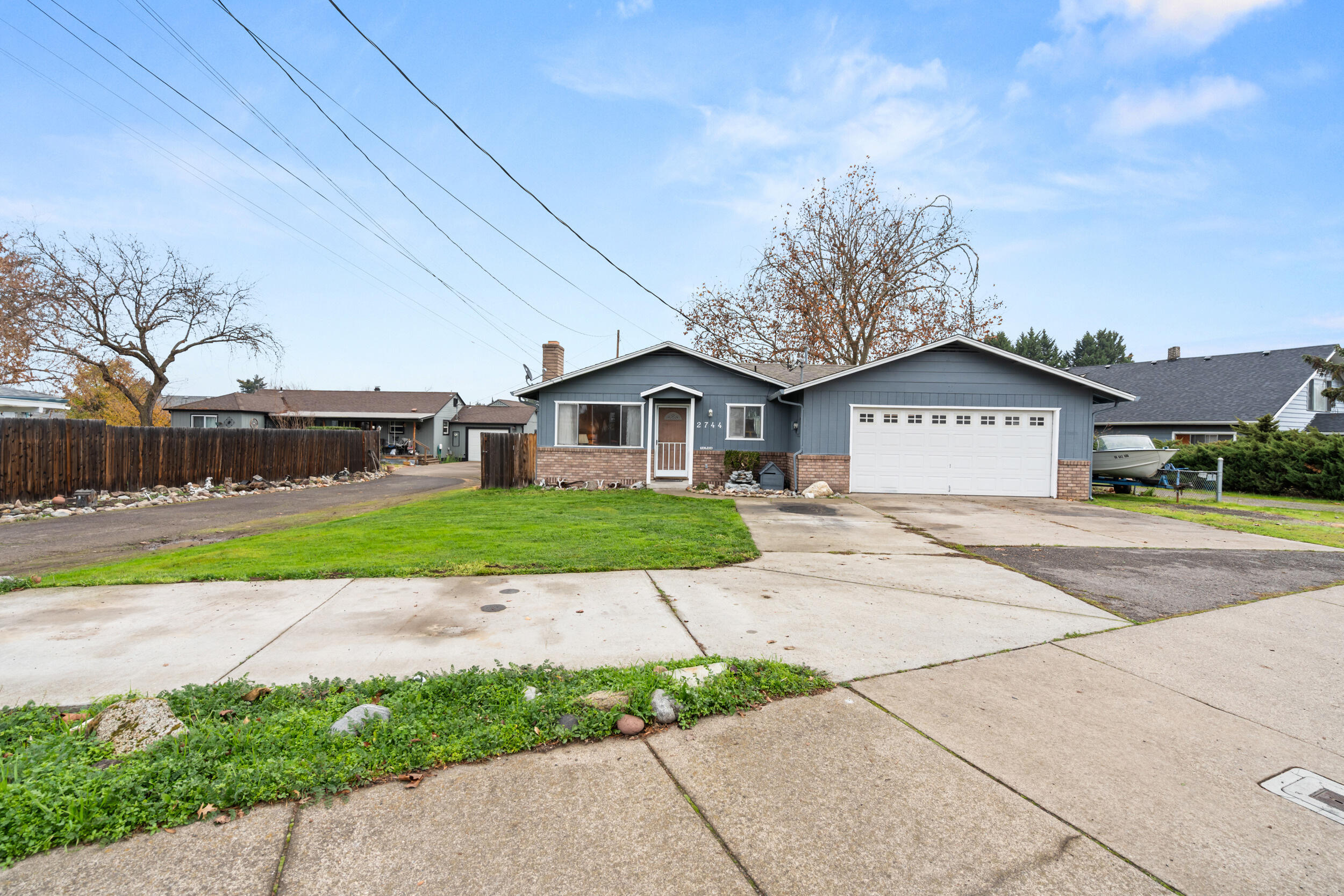 Charming 3 bed, 2 bath home with great updates throughout! Enjoy fresh interior and exterior paint, newer flooring, updated light fixtures, electrical plates, smoke/CO2 detectors, and a newer hot water heater. The roof is approx. 15 years old per seller and features new flashing. The spacious lot offers tons of parking, including room for extra vehicles and an RV. Centrally located for easy access to everything. The fully fenced backyard includes a giant shade tree, perfect for relaxing. Inside, a cozy wood-burning fireplace warms the living room, and all appliances are included—stainless steel dishwasher with matching gloss-black fridge and oven. Move-in ready and full of comfort!