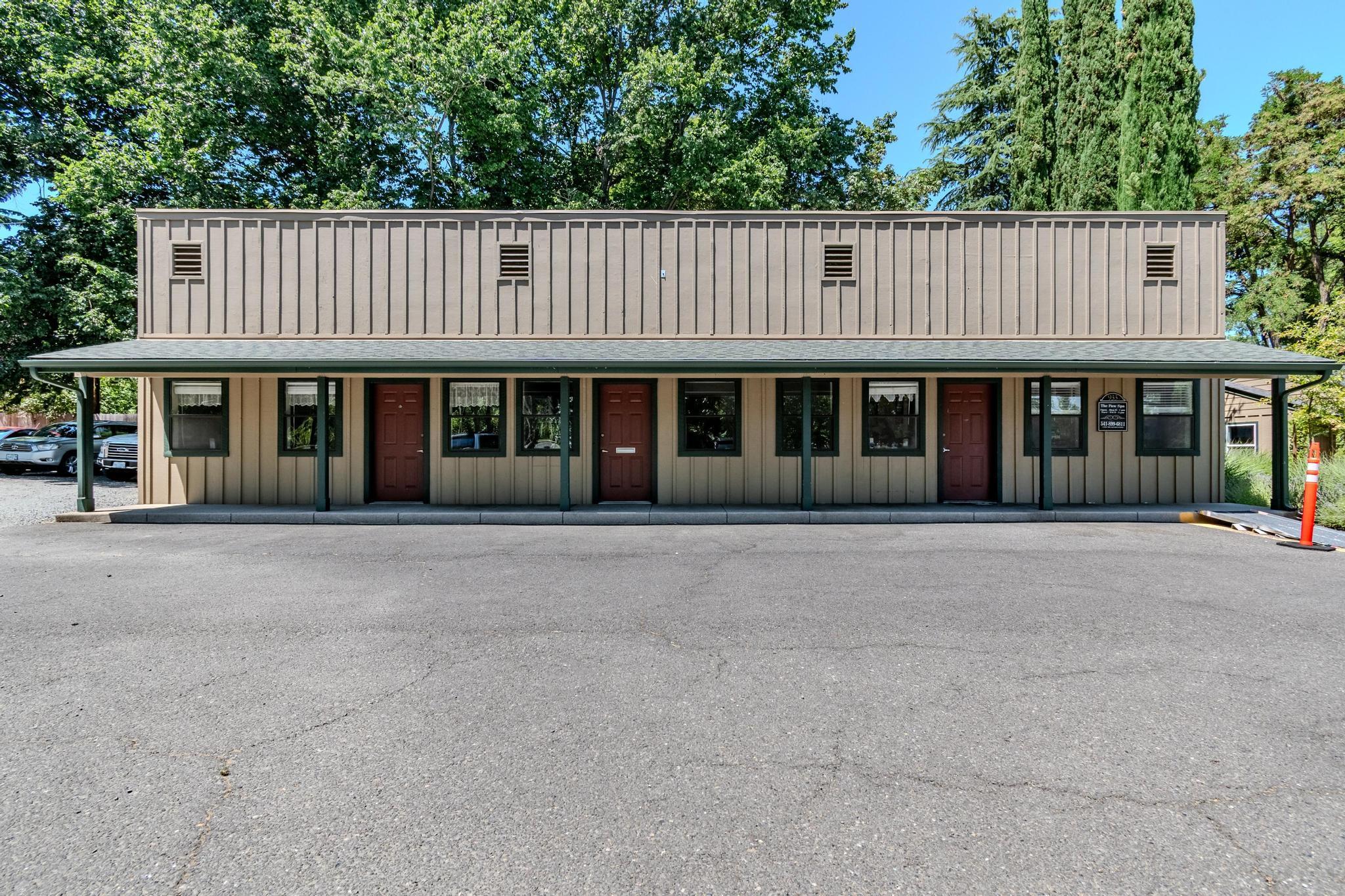 Professional Office Building with 4 suites, 2 bathrooms and kitchen.  Each suite has an exterior entrance.  Three suites have 2 private offices with a large office / reception area.  Paved parking for 9 spaces with additional 10 parking spaces available in adjacent gravel area.