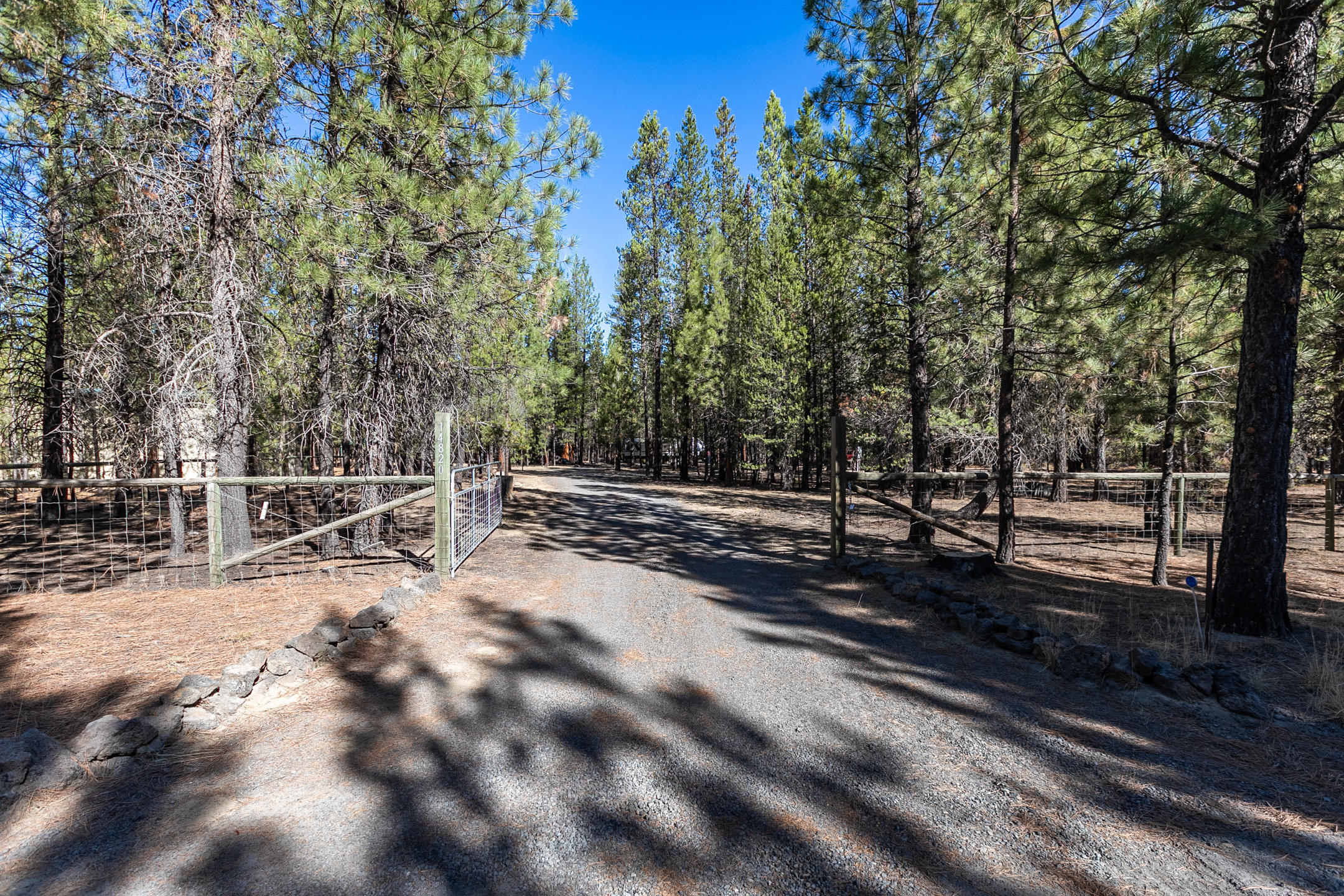 Beautiful flat, wooded building lot, with installed standard septic system, installed in 1999 by permit and suitable for a 3 bdrm/2 bath home. Water is provided through a community water association and 2 frost free bibs are installed and usable. Lot is located about 1/8 mile off paved area of Ponderosa Way. This firewise 2 acre lot has a graveled circular driveway and is fully fenced and gated. Two buildings are included, a 10x12 shed with storage and electricity, the other a 12x17 partially finished cabin, which has been used as a sleeping room. Two full RV hook-ups with water, power, and 2 dump stations. Currently used as a recreational site, it has a 2019 Forest River Vibe 36 ft trailer onsite and may be purchased outside escrow at an additional cost. Bring the family for vacation, hunting, or for your future building site with a place to live while the home is being built! HOA protected community with common areas that lead to forestland.