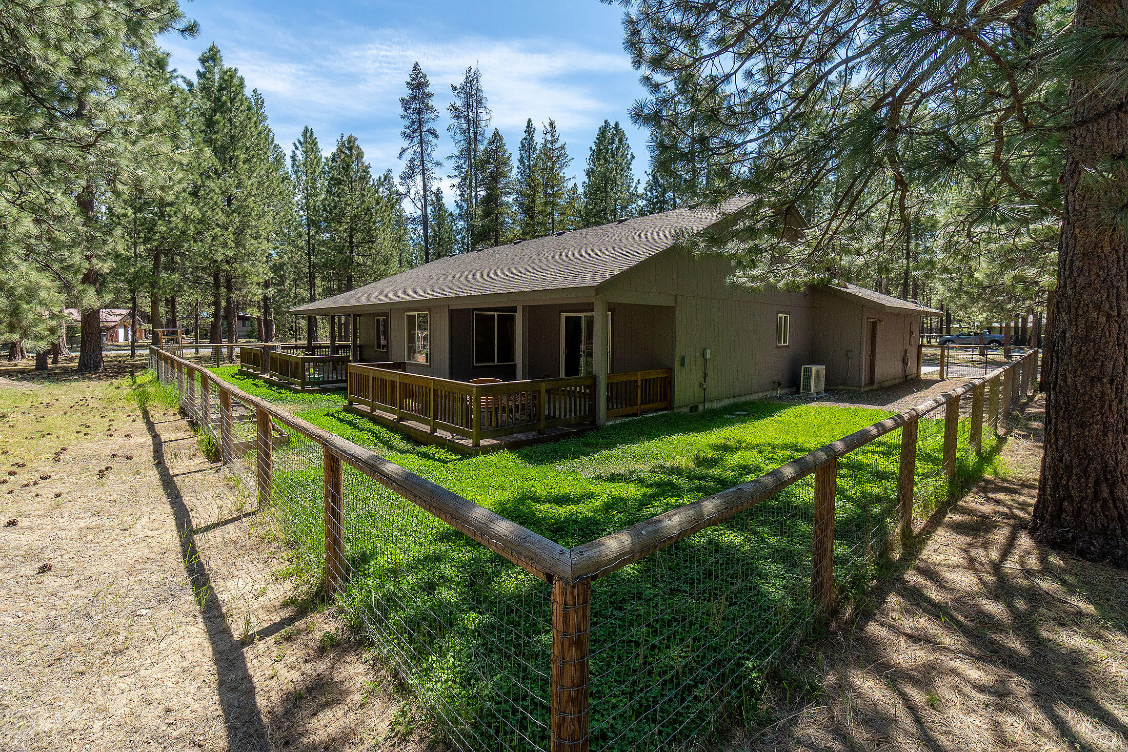 BRAND NEW roof, HVAC system for this charming single-story 4 bdrm, 2 bath home on 1.13 AC corner lot in desirable Ponderosa Pines neighborhood, which backs to acres of public & National Forest lands -Minutes to fishing, skiing, hiking & all the great recreation in in Central Oregon. Large primary ensuite w/private patio, walk-in closet, spa-like tiled shower. Laminate & tile floors. Guest qtrs separation. Excellent flow! Vaulted Great Rm floor plan w/propane gas fireplace & granite tile surrounds overlooks your forest view w/private, covered patios. Shaker-style cabinets, 3-car garage, 10 x 20 RV/Carport. Fenced area off decks for gardening, play or pet area. Room for a SHOP. AC/Heat pump. Sold w/appliances; newer gas stove & refrigerator & water heater, resurfaced front walkway/cement pad, primary bath remodeled! Dual entry driveway, paved roads. Wooden plantation blinds. Guardian Mortgage Lender offers 1% credit to closing costs, buydowns.