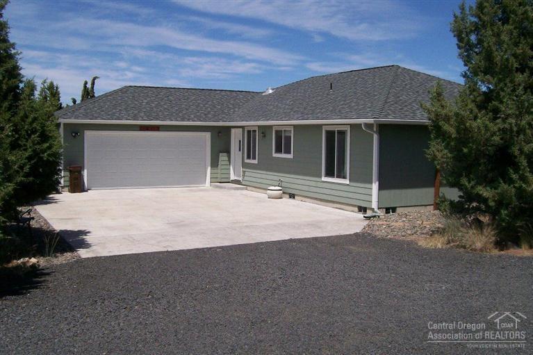 High Desert Estates Home w/plenty of room to entertain guests. You will love this 1802 SF home with great room floor plan, 3bd/2ba. Oversized open kitchen with SS appliances, patio off the back with nice view. Nice master suite with walk-in closet, double sink bathroom and slider to the back deck with hot tub. All of this on 2.09 AC a double attached garage and a detached studio/shop area with AC/heat & 220. Put this on your list of must see homes.