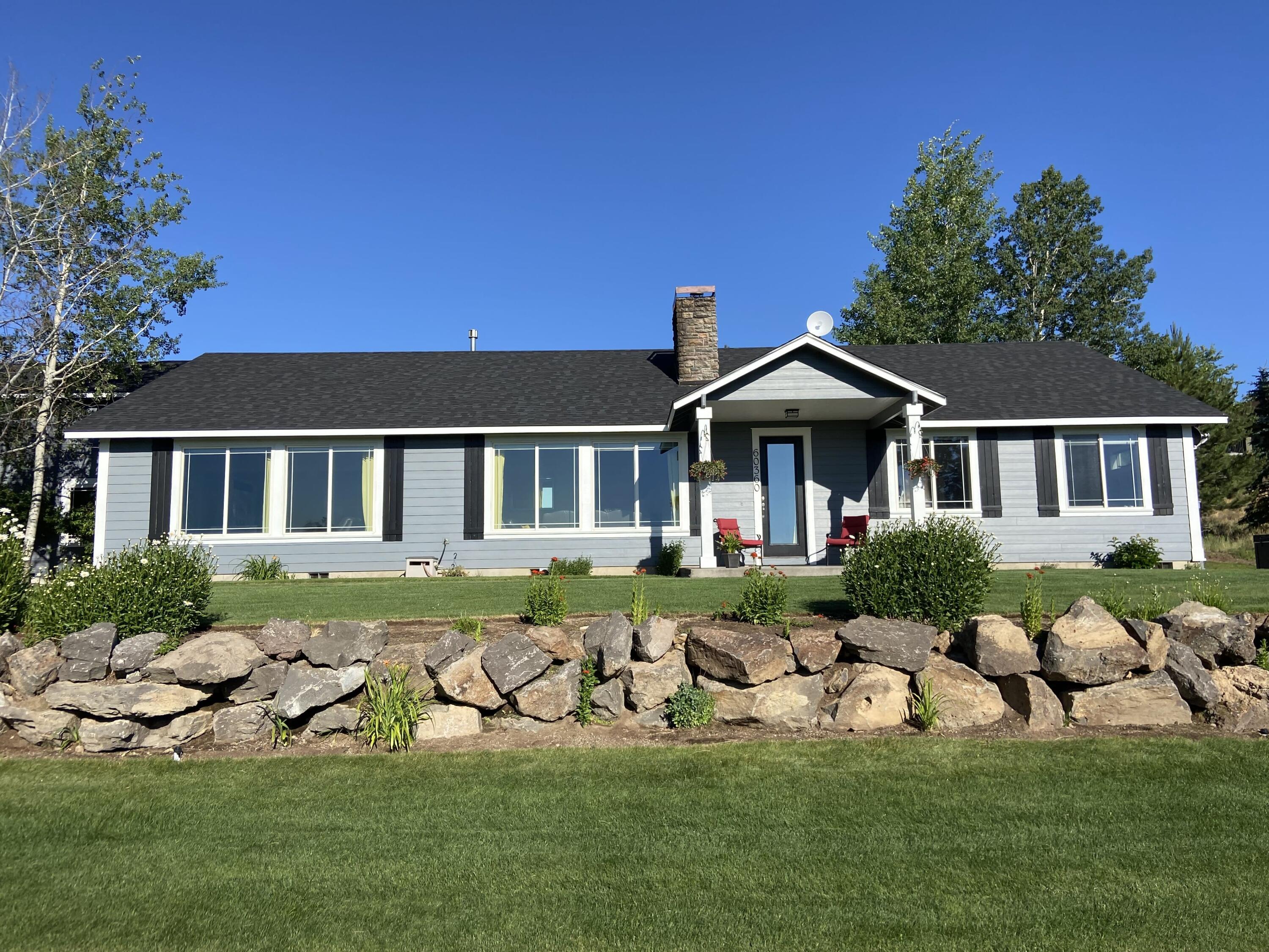 Amazing Cascade Mountain Views! This home is located on 1.97 acres of land across from a large common area that connects to BLM. Several trails right out of your front door. Looking out of the large front windows, all you will see is a spacious green yard, protected land, brilliant Central Oregon sky, and snowcapped mountains!  New exterior paint and a new roof on this single level home.  This beautiful home also has a detached garage/shop with living quarters on the 2nd level. Hardwood & tile floors throughout, vaulted ceilings, granite counter tops, fireplace in the great room, and custom designs. Lots of storage!  RV/boat parking, asphalt driveway. Wonderful garden area with built in irrigation. Hot tub included.   Main house is 2,850 sq. ft. and has 4 bedrooms with 3 full baths.  The living space above the detached garage/shop is 1,175 sq. ft. for a total of 4,025 sq. ft..  You will love this home in the quiet Conestoga Hills area of Bend, Oregon.