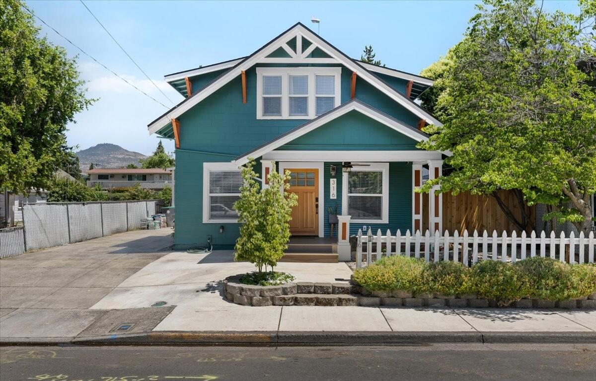 An East Medford home completely remodeled/updated in 2018 with the vintage feel in tack that was built in 1910. It is ready for commercial business or stay as a wonderful 2 bdrm/2bath residential craftsman home (zoned C-S/P).  Covered front porch with easy care landscaping.  Walk into this cozy living room w/ original hardwood floors, gas fireplace & lots of crown molding & amazing lighting throughout.  Dining has French doors to the deck & separate large, heated workshop/garage with drive thru. Indoor laundry with lots of windows.  Kitchen has granite counters, a beautiful wood counter at ''coffee bar'', newer matching appliances & walk-in pantry.  1/2 bath at stairway with vintage charm, that is carried upstairs as well, with the full bathroom, the primary w/ 2 closets one a ''walk-in'' closet & 2nd bedroom. All electrical & plumbing replaced & new roof. Painted inside & out. RV parking w/ hook ups. Walking distance to park, shopping, restaurants, theater and is move in ready!