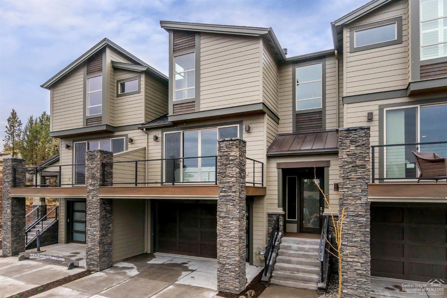 This spacious townhome you'll find tucked in Rivers Edge Village in a secluded new home community. Walk out your front door and be on the Deschutes River Trail within just a few steps. This community is close to shopping, parkway access and within minutes of The Old Mill District and Downtown Bend. The home features luxurious finishes, an open and airy floor plan with lots of natural light. In the Mahoney Plan you'll experience an open floor plan experience with space for entertaining, gourmet kitchen and large eating bar. The large master suite has a large tiled shower, dual vanity, large walk in closet, separate water closet, and the 2nd bedroom offers an en-suite bathroom, bonus space with a full bath and separate office. Great room with gas fireplace and built in cabinets. The large deck views of Pilot Butte, great for watching the fireworks. Included are numerous smart home features that complete this home. Photos are of actual home.