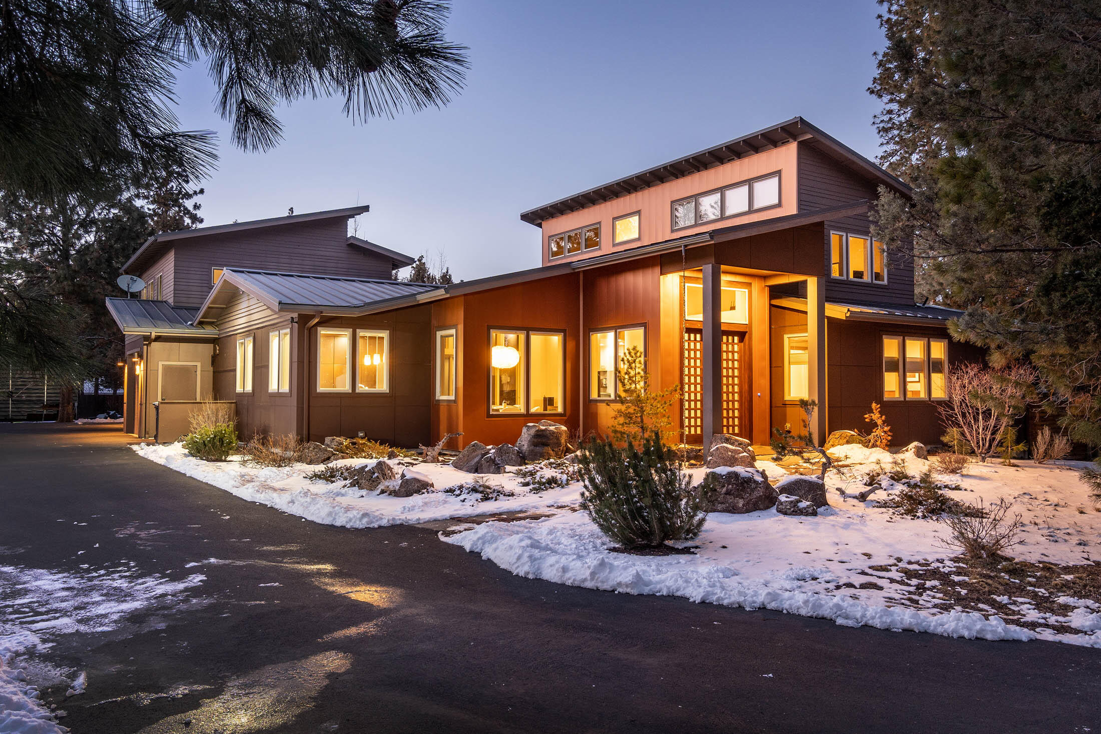 A stunning contempory-style residence located in walking distance to the Old Mill and the Deschutes river trail. Situated on roughly half an acre in the peaceful and sought after Woodriver Village community, this custom built home comes equipped with numerous luxurious amenities and is the ideal home for those looking to be in the heart of all that Bend has to offer! 
Entering the 2,985 sq ft main house you're greeted with high ceilings and a welcoming living room. There are two primary bedrooms on the main level, and an additional bedroom plus bonus room/office on the second level. The primary rooms are thoughtfully designed to be as spacious as possible, each with walk-in closets and resort-style amenities including a soaking tub and steam shower. The kitchen contains custom built cabinets, quartz countertops, and stainless steel appliances. Separate is a fully equipped 600 sq ft ADU above the 3-car heated garage and an additional covered 30x40 RV storage with electrical hookups.