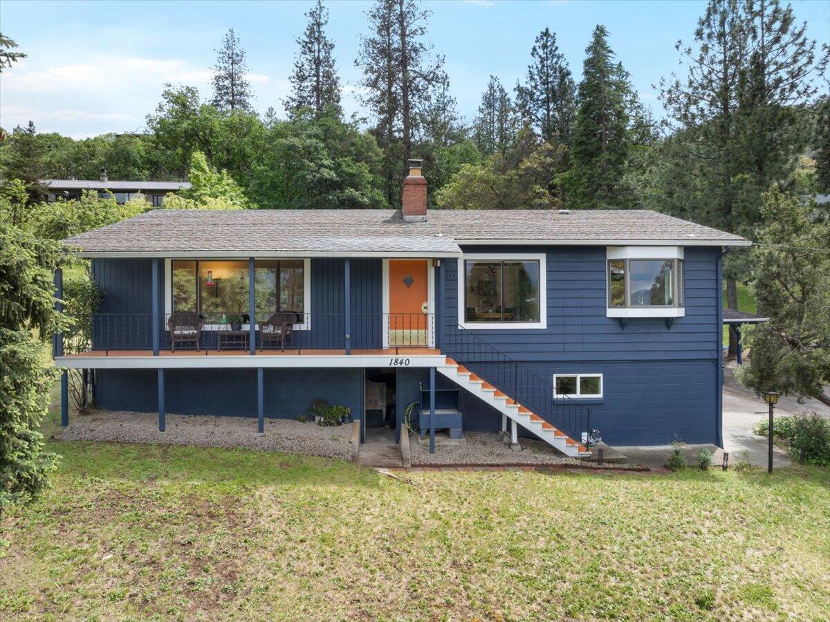 Midcentury Modern accents, sweeping views and a huge, private lot make this home special. Oversized windows frame peaceful mountain views in the living room, while refinished oak floors gleam in the sunlight. A wraparound fireplace separates the living room from the open kitchen, family room and dining area. The kitchen's thoughtful remodel makes cooking a joy, with new appliances, granite countertops, a breakfast bar and cleverly designed space-saving cabinets. An open family room with shelving and sliding doors to the outside makes a cozy media center or office. Two bedrooms and an updated full bath with custom tilework, separate tub and tiled shower round out the upstairs. The lower-level third bedroom has its own entrance, updated full bath and laundry closet--ideal for guests, teens or work-from-home. The 0.38-acre lot with irrigation rights backs up to the TID ditch and trail, a perfect spot for hikes and dog-walking. A sunroom lets you enjoy your backyard oasis year-round!