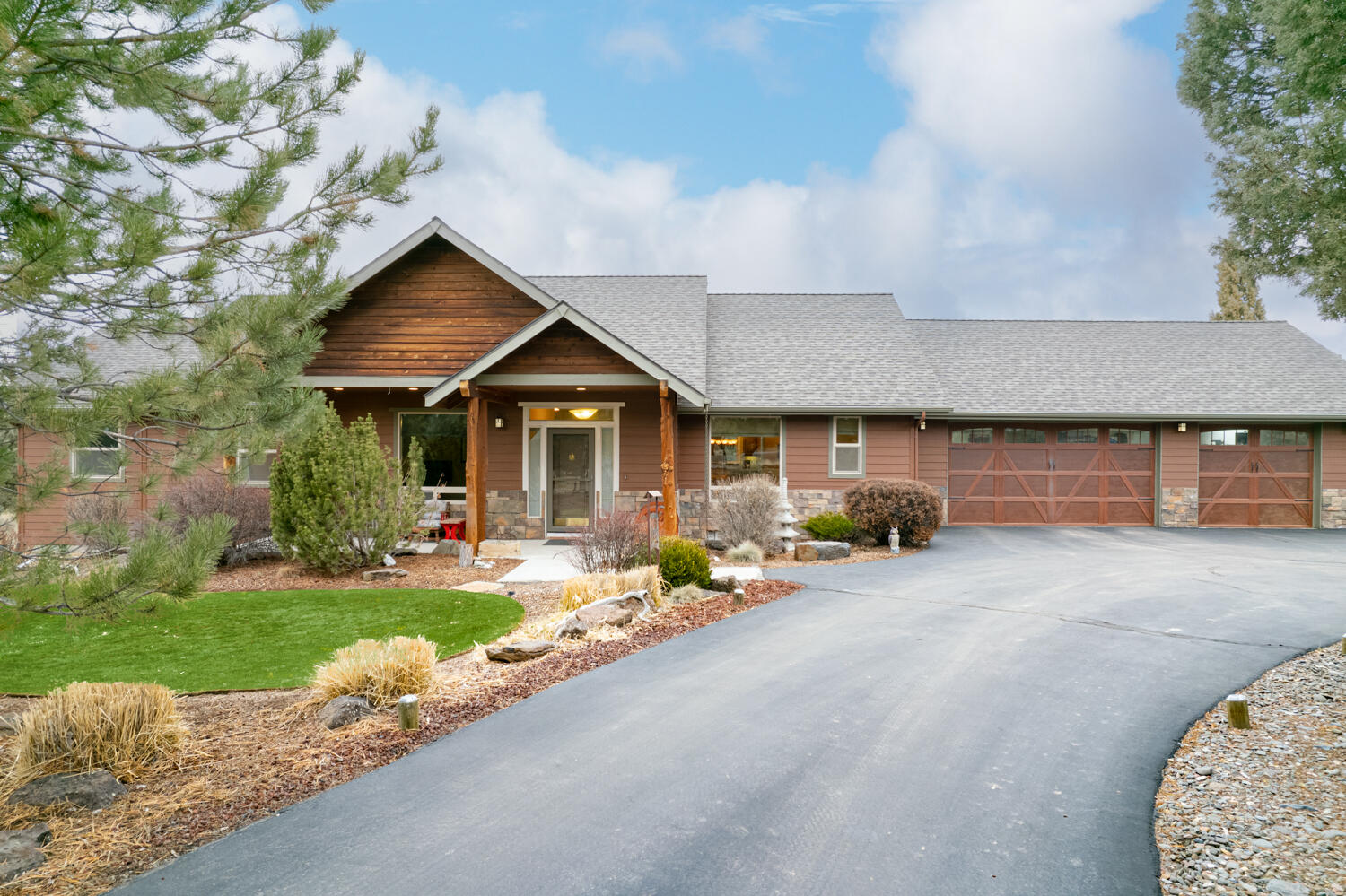 Do not miss this gorgeous custom home nestled on 2 acres in the heart of Central Oregon w/multi-generational living or private guest accommodation + HUGE shop. Covered front porch leads to an open tiled entry & formal dining area w/built-in wet bar. Open concept great room plan ftrs hardwood floors w/plush carpeted living space, floor-ceiling stone propane fireplace w/mantle, vaulted ceilings, & an abundance of natural light. Kitchen ftrs breakfast bar seating, tiled counters, full height backsplash, built in oven, gas cooktop, & walk-in pantry. Primary suite w/vaulted ceilings, walk-in closet, & bathroom ftrs double vanity, tiled corner soaking tub, step in shower. Addtnl bedrooms share full bath. Oversized laundry room w/sink, built-in cabinetry, & counter space. Hot tub, firepit, xeroscaped backyard. Main house is 3 bed 2.5 bath. 2 apts are 1bed/1bath; 400sf each. 3 bay shop w/RV height doors, covered entry, 36x36 floorspace, hidden storage cellar in shop closet. Gated Community!