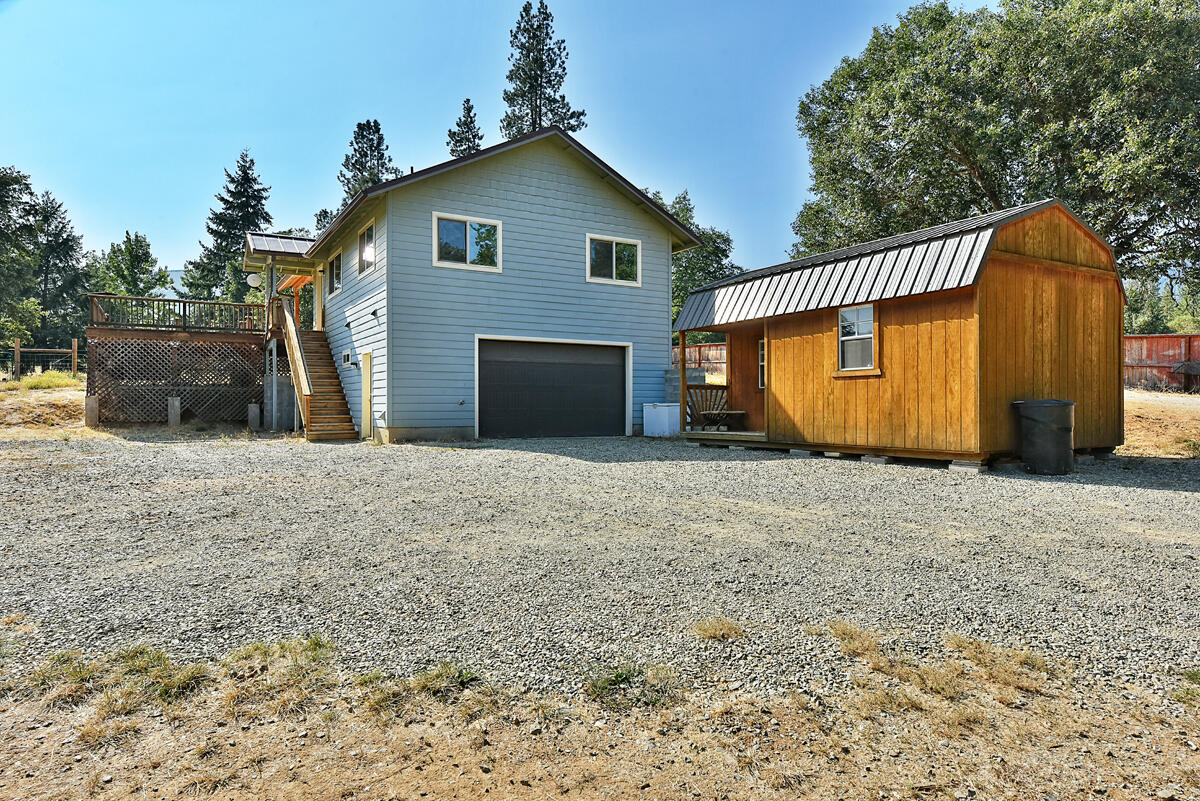 Beautiful 5+ acre property with plenty of sun and flat to slightly sloped acreage. The cozy and beautifully built home has hardwood floors, granite counters, stainless steel appliances and vinyl windows. Downstairs is a finished shop / garage with a full bathroom. Outdoor entertaining is easy on the huge covered deck and you'll love soaking in the gigantic hot tub. There is a newly built lean-to with 4 stalls and the property is fenced and cross fenced making it an ideal horse property. The luscious garden is fenced in and has irrigation set up. A tiny artist studio with electricity offers a variety of uses. A nearby shed has a washer and dryer (there is also a hook up in the garage of main house). This mini-homestead is ready and waiting for you!