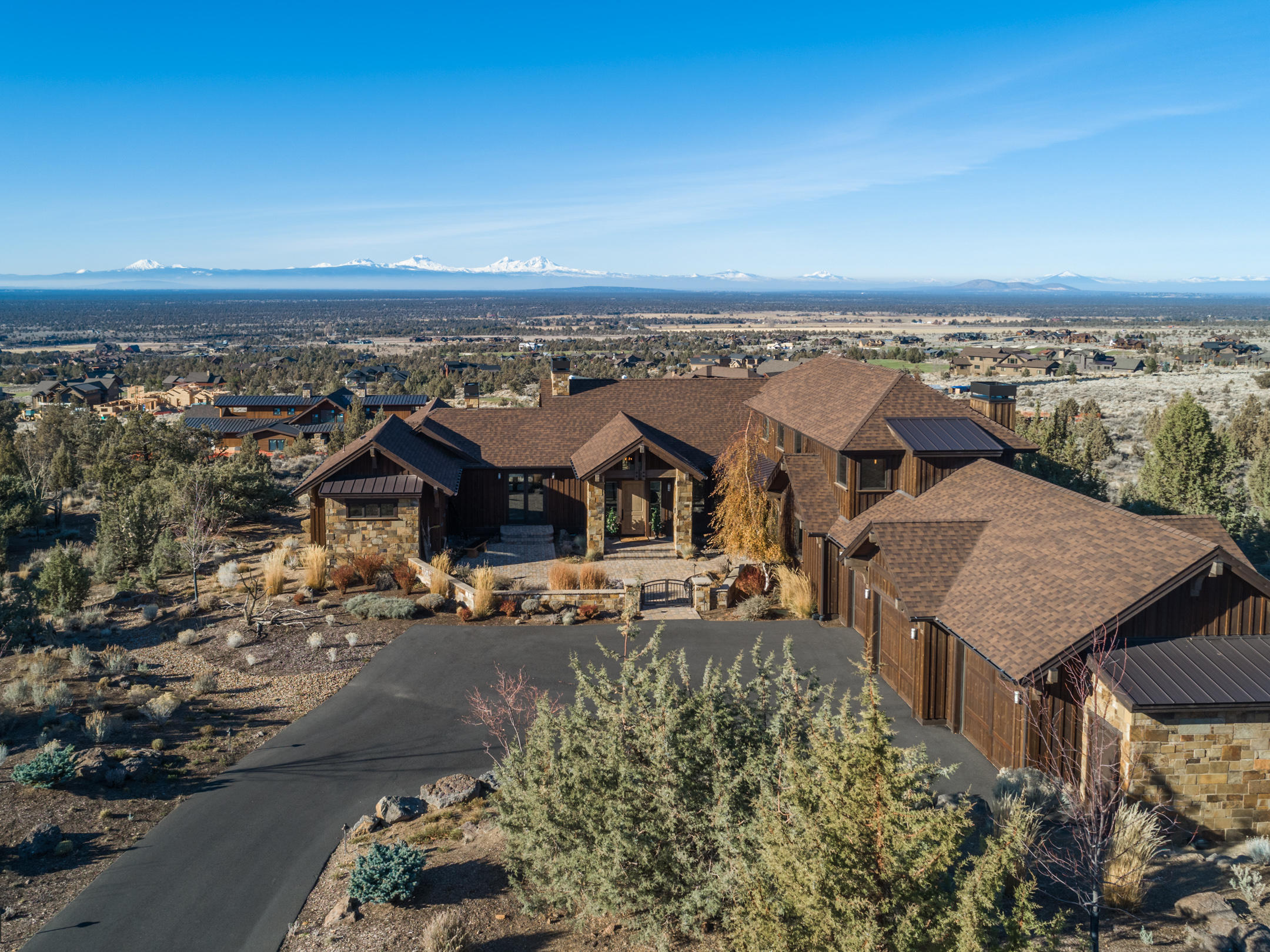 BRASADA RANCH CUSTOM HOME. Cascade Mtn Views from ALL BDRMS, Great Room, Kitchen & Upstairs Bonus.  Quality materials were selected! Wide plank hand scraped hard wood floors, solid surfaces, fully tiled showers, wood truss beams, paver deck, surround sound and Control4 smart home system with remote access. Primary Bdrm on the main level with gas fireplace, bath has separate vanities with under cabinet lighting & step up jetted tub. All bedrooms have walk in closets with built-in dressers, cabinets & shelves. Lg. second Bdrm on main level with ensuite. Unique downstairs with theatre room, large screen wall mounted TV, sound system, 10 movie theatre chairs, classic diner with booth seating, a wet bar with dishwasher, two additional flex rooms, 1 full bath and built in bunks. The laundry room also makes a great space for your craft projects with plenty of counter space and built in cabinets. Home is move in ready, includes all home furnishings with a few exceptions. Below grade Sq Ft 1290