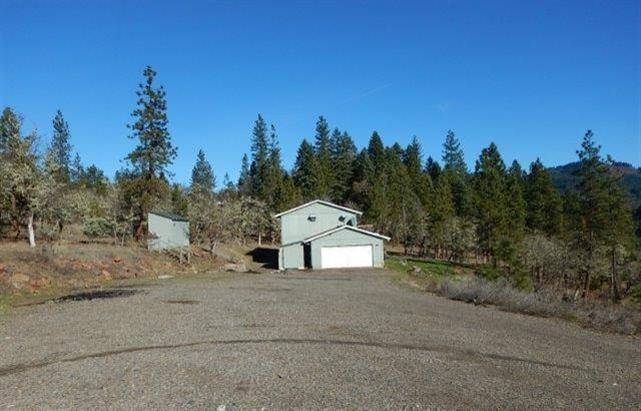 Two-story 4 bedroom, 2 bath home on over 5 scenic acres in Trail. Outside is a covered front porch perfect for entertaining or just enjoying the view. Inside, home has a large kitchen with lots of cabinet space and built-in island/bar area, laundry room just off kitchen for ease of use, and LOTS of natural light. Attached garage and shed to cover all your storage needs, and if that's not enough, secondary detached shed gives you even MORE space. HURRY, this one won't last long!