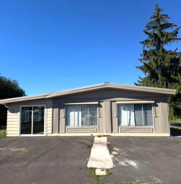 Two lots! Home-lot 800 and Garage-lot 700. Garage is 672 sq ft., Home is 1344 sq ft and a 540 sq ft enclosed front Porch. The home has a Large Living Room/Dining Room, Den off of the Kitchen, Walk in Closet in the Primary Bedroom, Newer Walk-in Tile Shower, New Laminate Floor, Double Sinks, Laundry Room, Kitchen has newer Dishwasher, Oven, and Refrigerator. A/C and Electric FA Furnace, Metal Roof on the home. Garage has a new roof, Cement floor and work shelves. New Storm door on the enclosed Porch. Seller is  an Oregon Licensed Broker and owner of this property.