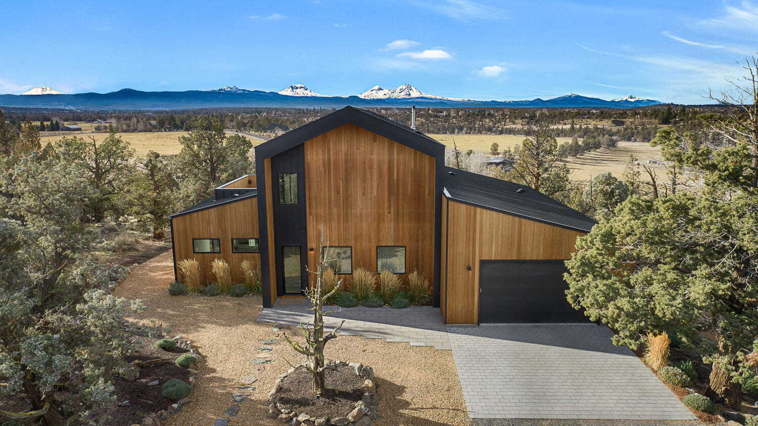 A rare legacy property with sweeping Cascade Mountain and Deschutes River views, this Scandinavian-inspired retreat blends modern craftsmanship with timeless design. Built in 2021, the residence offers 3 bedrooms and 3.5 baths, curated for privacy and effortless luxury. Custom concrete countertops, Baptista tile accents, and a chef's kitchen appointed with Thermador appliances reflect exceptional attention to detail. A dramatic five-panel folding door system seamlessly connects indoor living to the outdoors, capturing the home's expansive natural surroundings. Set on over four acres of non-irrigated, native landscape, this private sanctuary offers a profound sense of space, serenity, and connection to the land.  The detached 2 bedroom guest house provides for multi-generation living or a private space for guests.