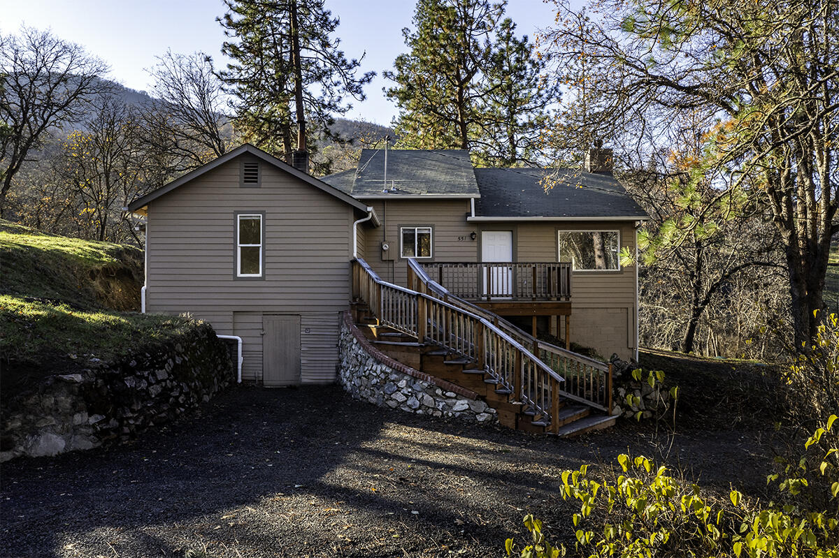 BANKS LAUGHED AT LOW RATES AND LOW PAYMENTS - WE SAID YES! CHEAPER THAN RENTING WITH OUR SUPER CREATIVE OWNER-CARRY TERMS! Call for details!  Sweet home on 10 acres right in town in beautiful Ashland. Newly refreshed with interior paint, new carpeting, driveway has been improved & new staging.  Rare offering with room to roam on 10.03 acres, zoned RR-5 in urban growth boundary! Located at the edge of the desirable Wrights Creek neighborhood, this gem is awaiting its new owner. Sweet 1372 sf home.  Buyer to do own diligence with City to determine potential for adding additional structures. Vaulted ceiling, nice fireplace with stone tile-surround & windows overlooking the natural setting, trees & open meadow. Kitchen is updated with granite counters & in-kitchen dining. 3 bedrooms & 1 bath on main level plus laundry room. Upper attic loft area is vaulted, finished & makes a great bonus space, office or bedroom. Private setting.