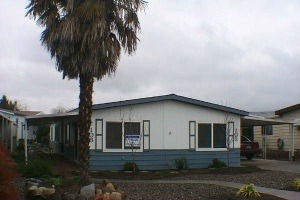 LOVELY MAN. HOME IN PARK. Very light and bright, remodeled with textured walls, updated kitchen and appliances, pantry, newer carpet and vinyl, built in china hutch, skylights, open bar, newer roof, two covered patios and fenced back yard for small pet. Sp. #103 $39,900