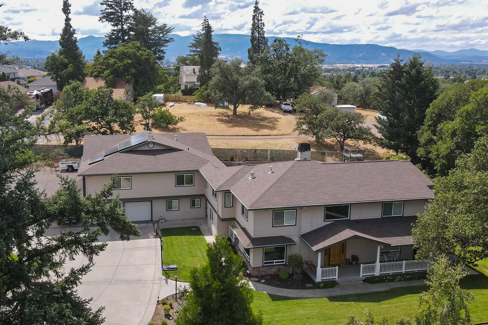 Here it is! A 2 family set-up just minutes from downtown Medford. This is a one of a kind property that has numerous possibilities! With .74 of an acre, property like this does not come along very often.  Main home is 3800 sq. ft. W/ 5 bed 3 full baths.  Second dwelling 1783 sqft  2 bed 1 bath.  Main home master bath has heated floors + it's own private deck. Huge kitchen w/ Stainless Steel Appliances, Dual fuel commercial grade range and built-in fridge. Media room with built in entertainment center and a Bose system throughout home & outside. Fenced backyard with saltwater pool and auto cover.  Huge shop with 12' roll up door, 15' ceiling, + large covered and gated RV/boat parking with RV hookups & a 2 car garage with covered carport and a 14,000W  Solar system.  Centrally located between Providence and Rogue Valley hospitals